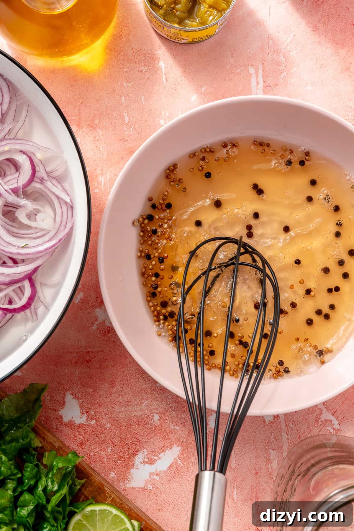 Sliced onions in bowl of water. Onion brine in bowl next to them.