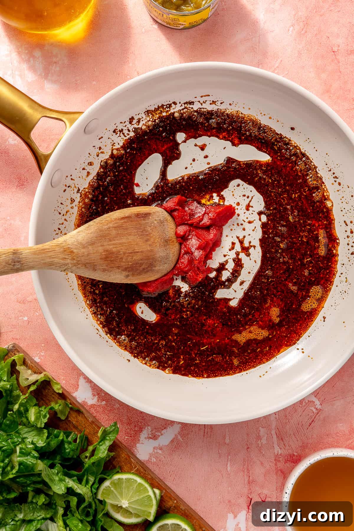 Sauce for chicken in skillet with tomato paste not fully mixed in yet.