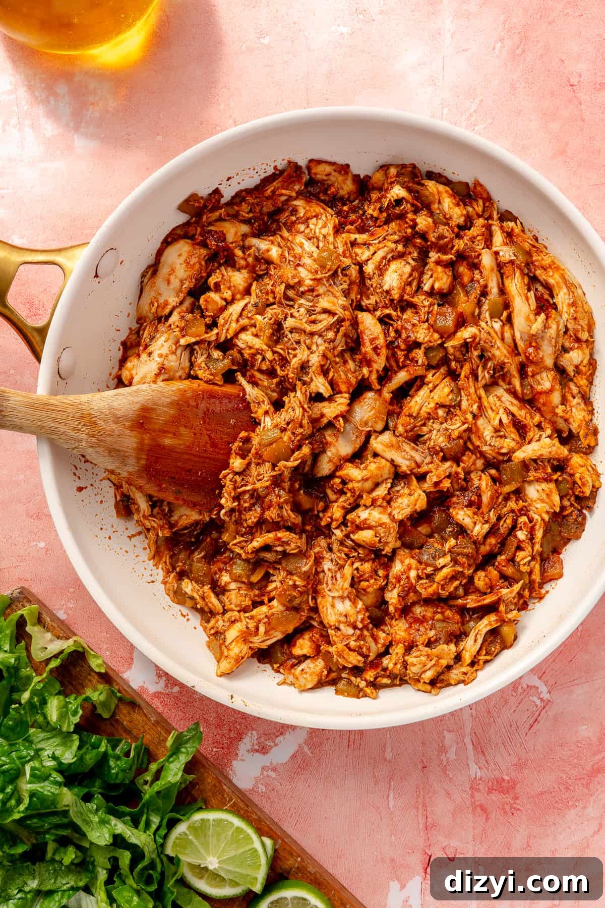 Rotisserie chicken mixed in skillet with sauce.