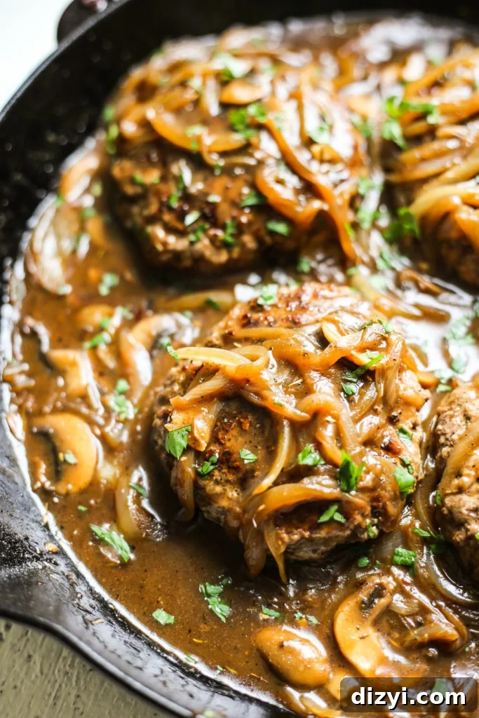 Hamburger steaks cooking in skillet