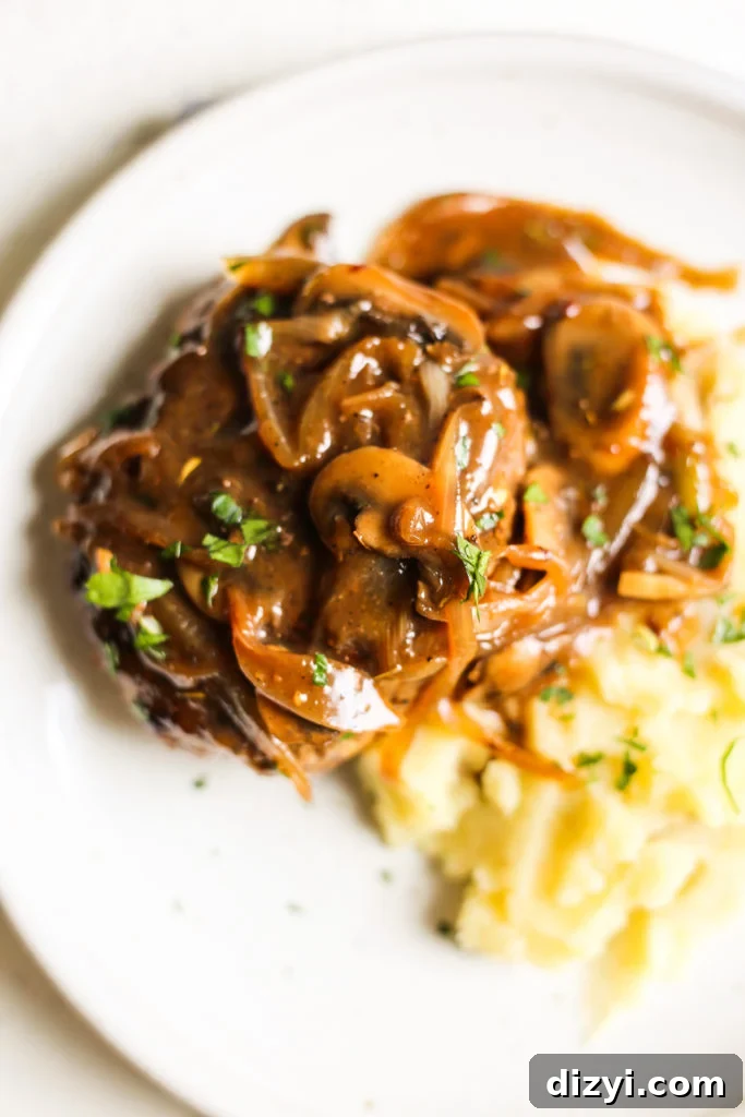 Southern-Style Hamburger Steaks with Onion and Mushroom Gravy plated