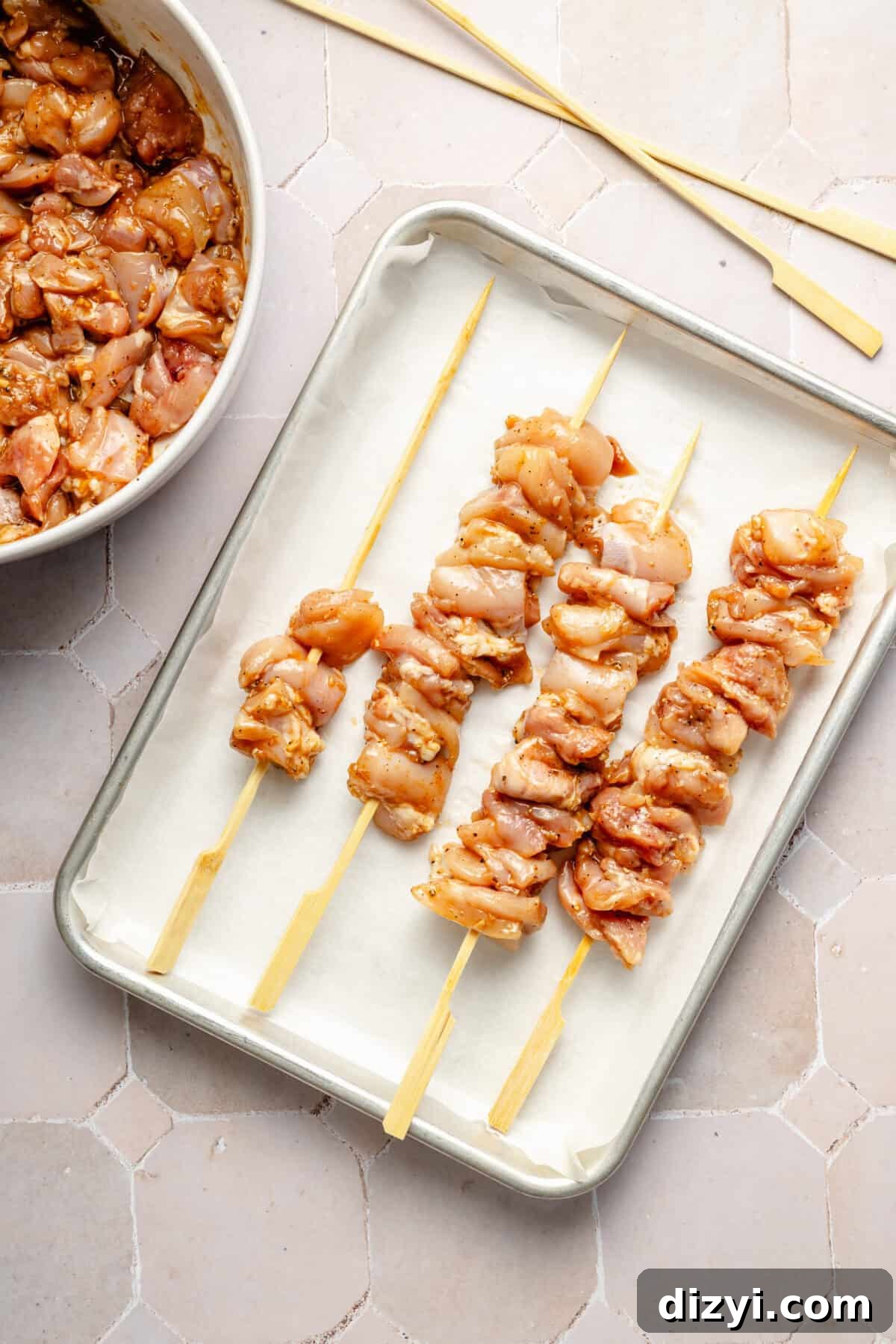 a sheet tray of chicken skewers for grilling