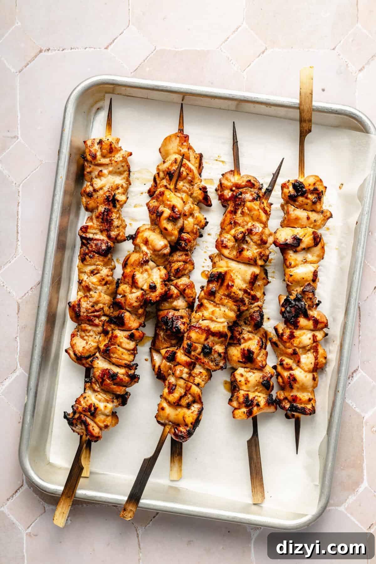 grilled sesame chicken skewers on a sheet tray