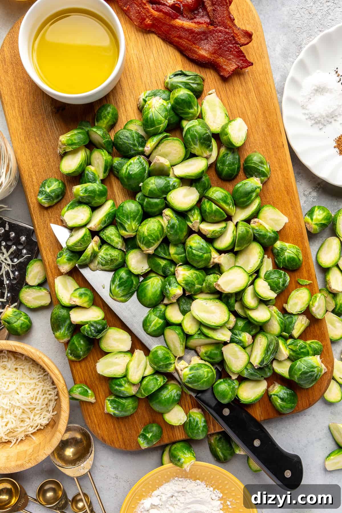 Cut Brussels sprouts on cutting board with knife for Brussels Sprouts Au Gratin.