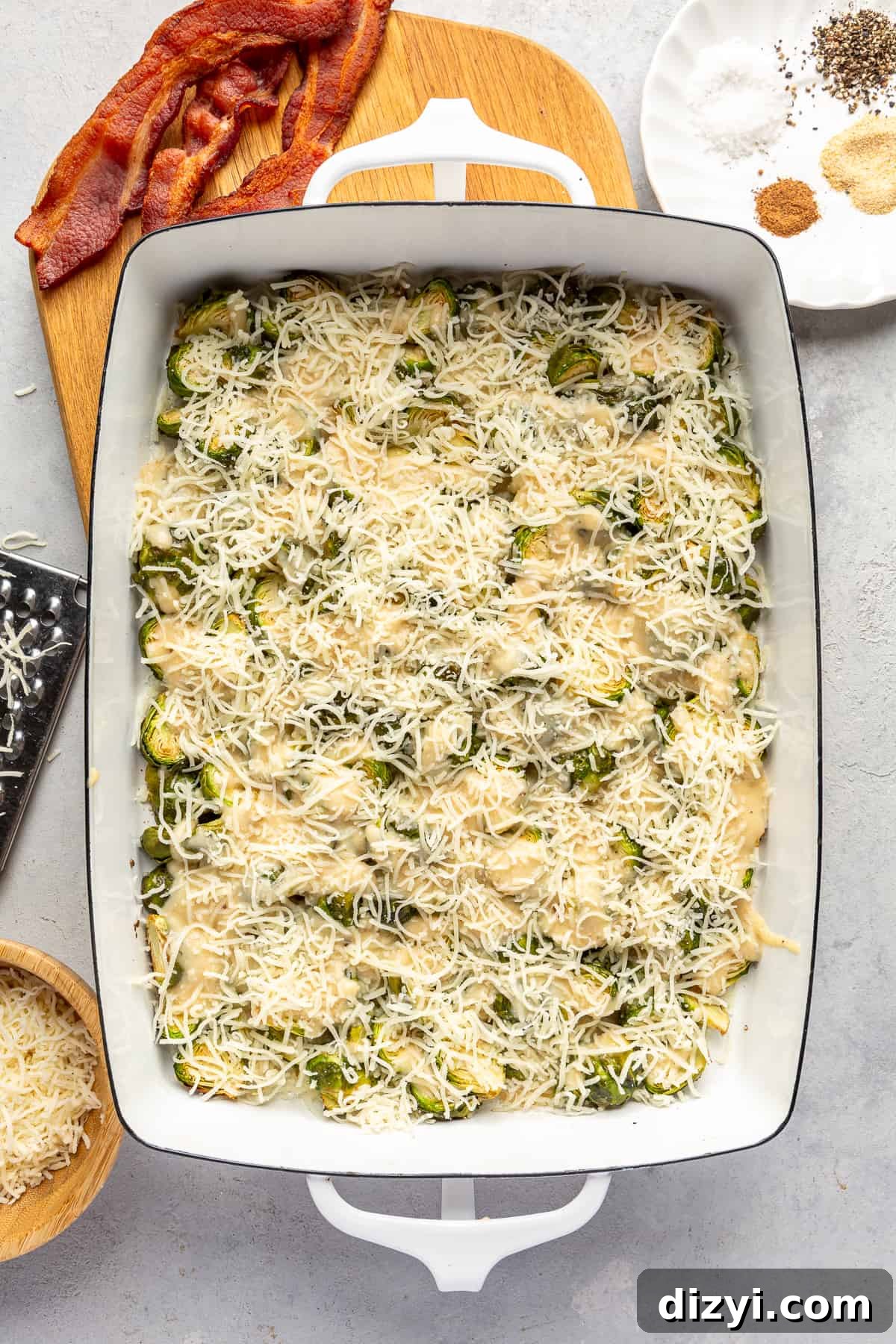 Au gratin assembled in baking dish with cheese on top before baking.