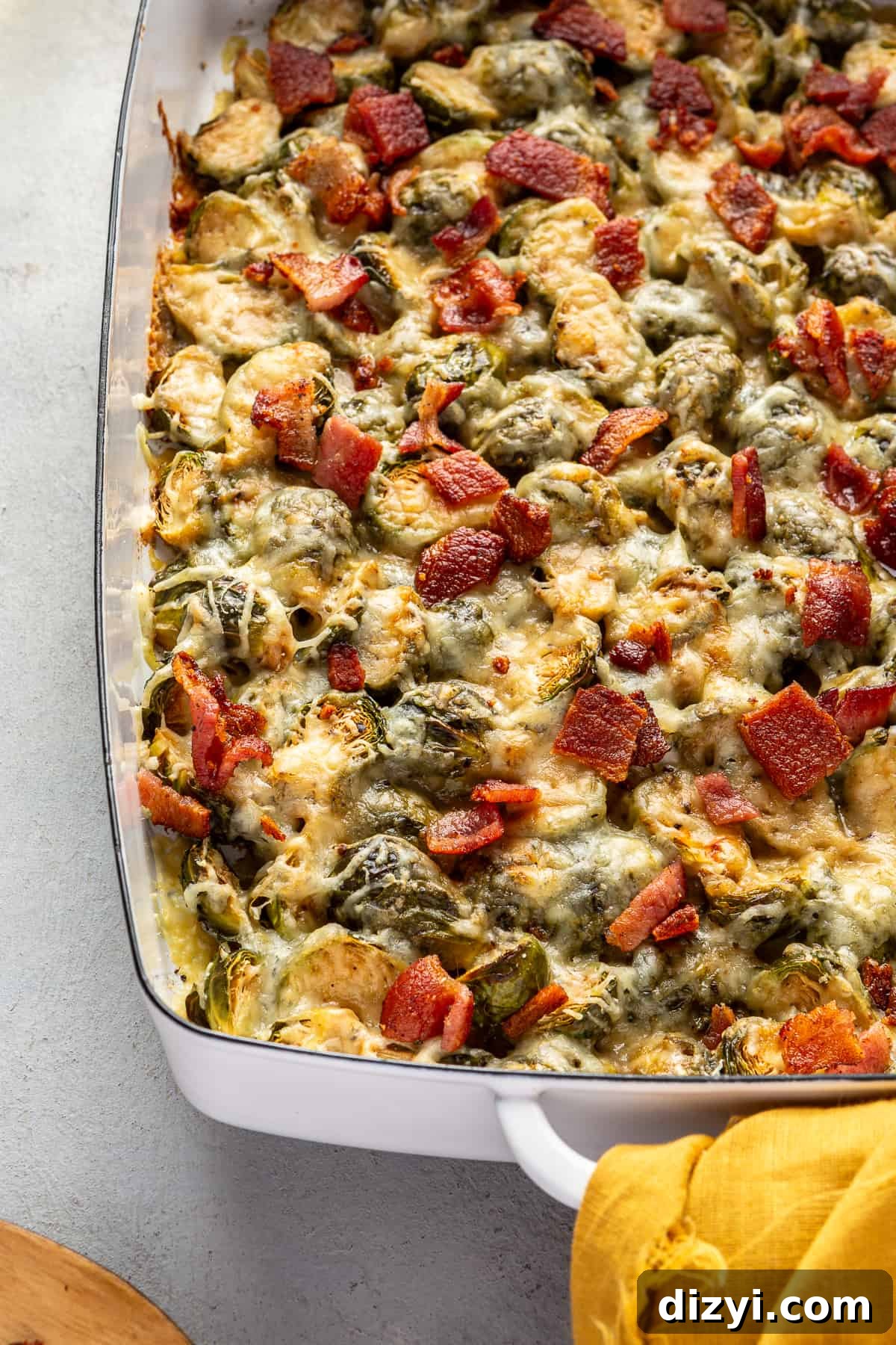Close up of Brussels Sprouts Au Gratin in white baking dish.