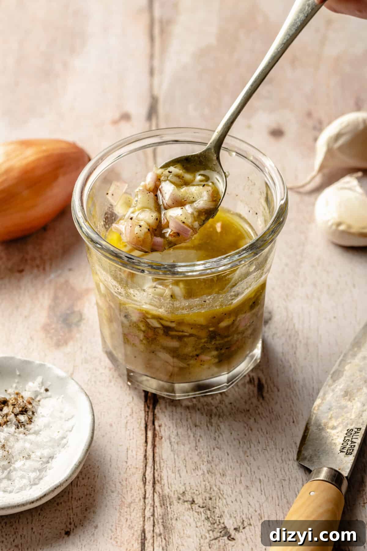 Bibb Lettuce Salad with Black Truffle Vinaigrette and Mimolette Recipe 3 Black truffle dressing in jar. Spoon lifting some dressing out.