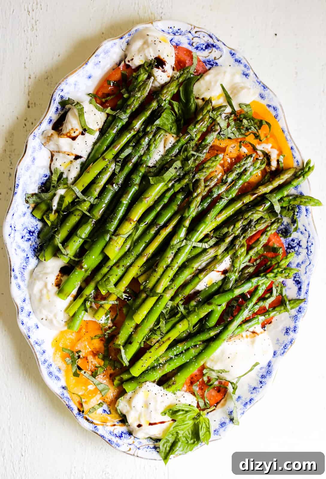 asparagus and tomato caprese salad with burrata and herbs