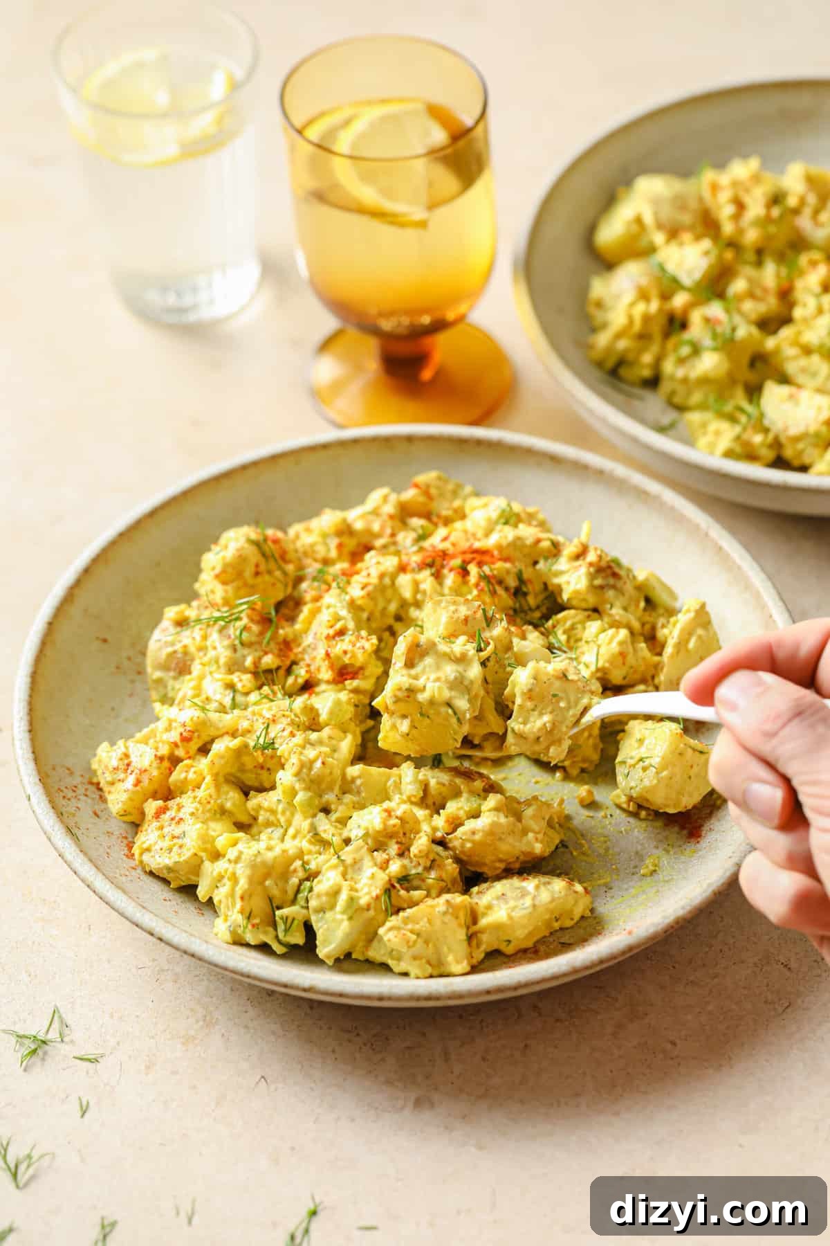 Scooped portion of potato salad showing texture and mustard flecks
