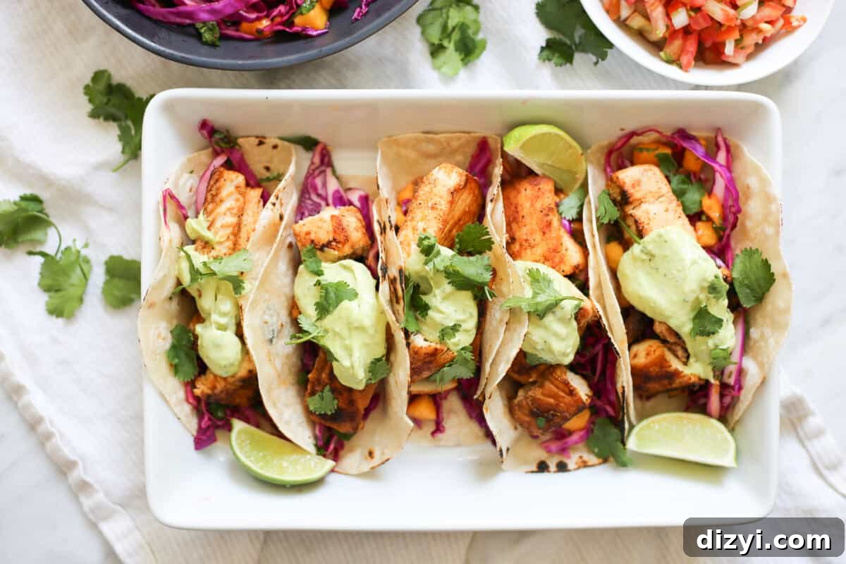 baja fish tacos with mango coleslaw and avocado crema