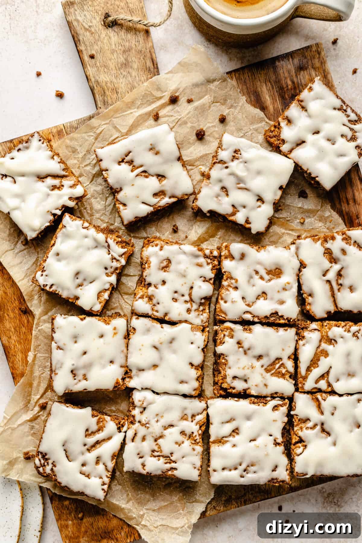 Iced Oatmeal Cookie Bars sliced on wooden board.