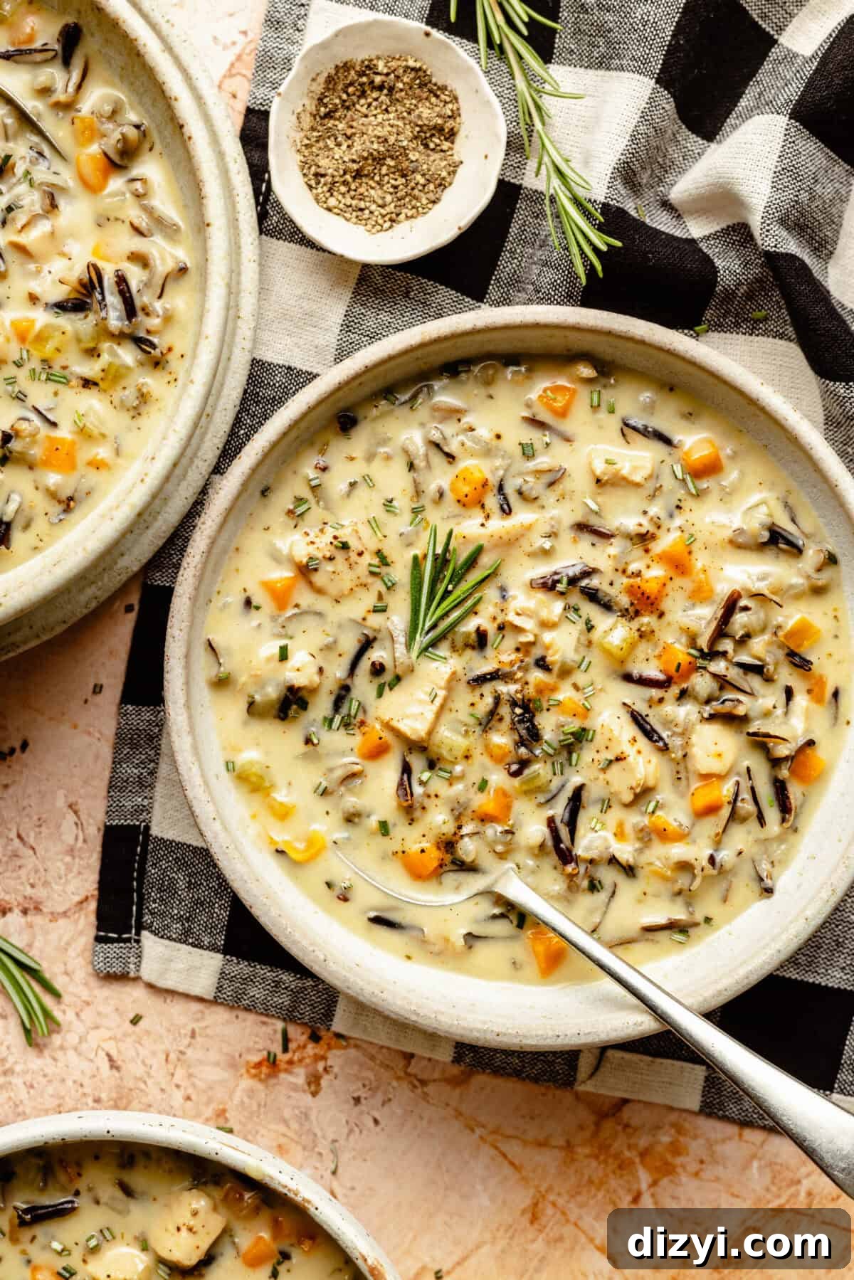 Leftover Turkey Recipes to Reinvent Dinner 4 A finished bowl of Dairy Free Chicken and Wild Rice Soup on a black and white gingham placemat.