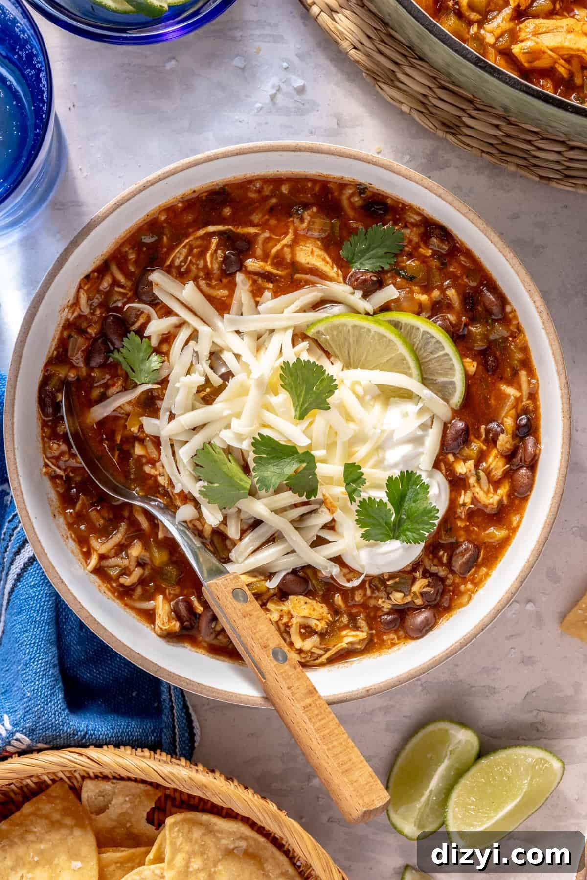 Leftover Turkey Recipes to Reinvent Dinner 6 Chicken and Rice Enchilada Soup in bowl with toppings.
