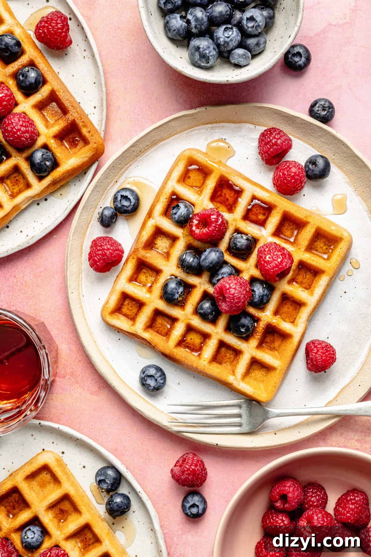 Paleo Protein Waffles  on plates with berries on top.