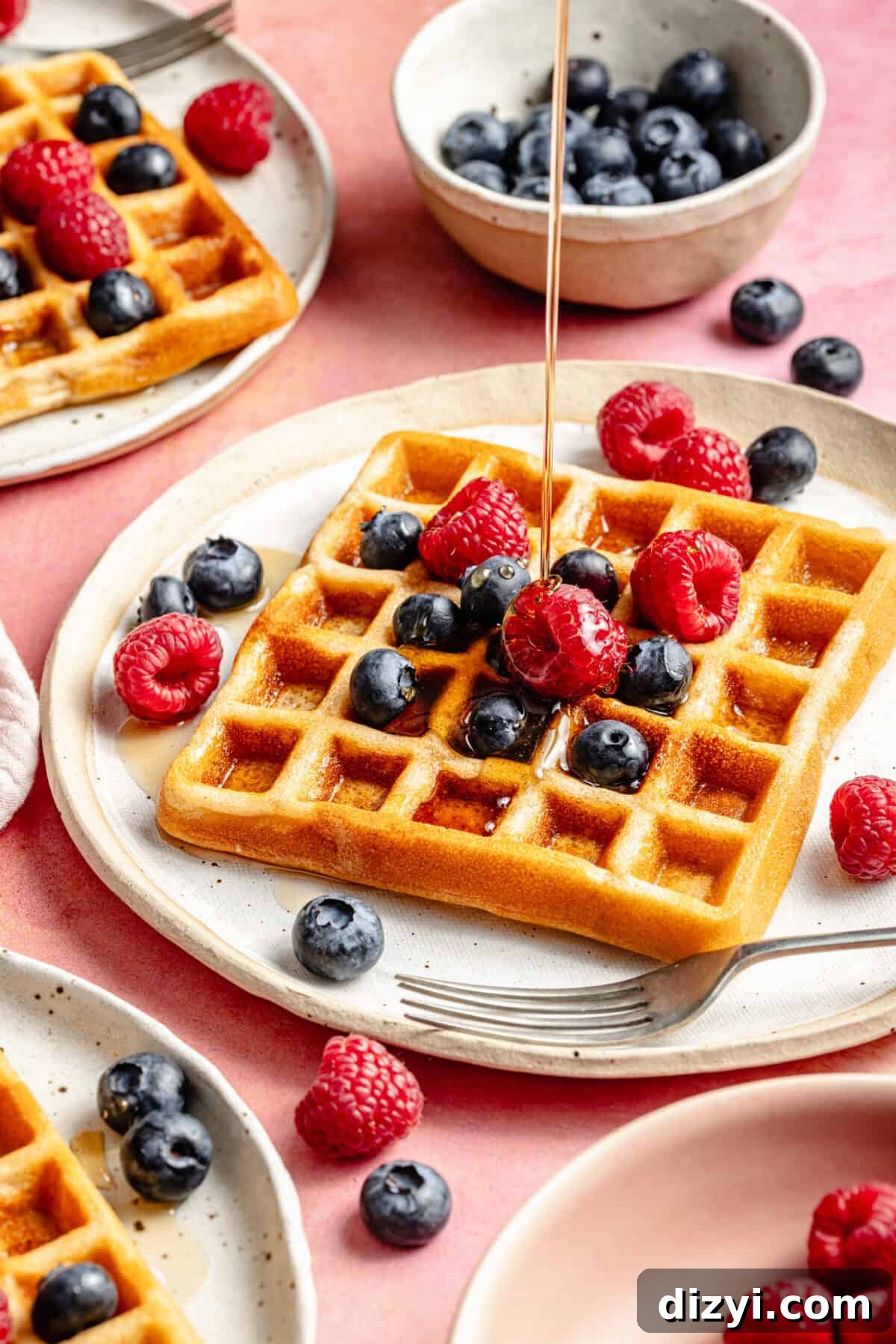 Paleo Protein Waffles with berries and syrup.
