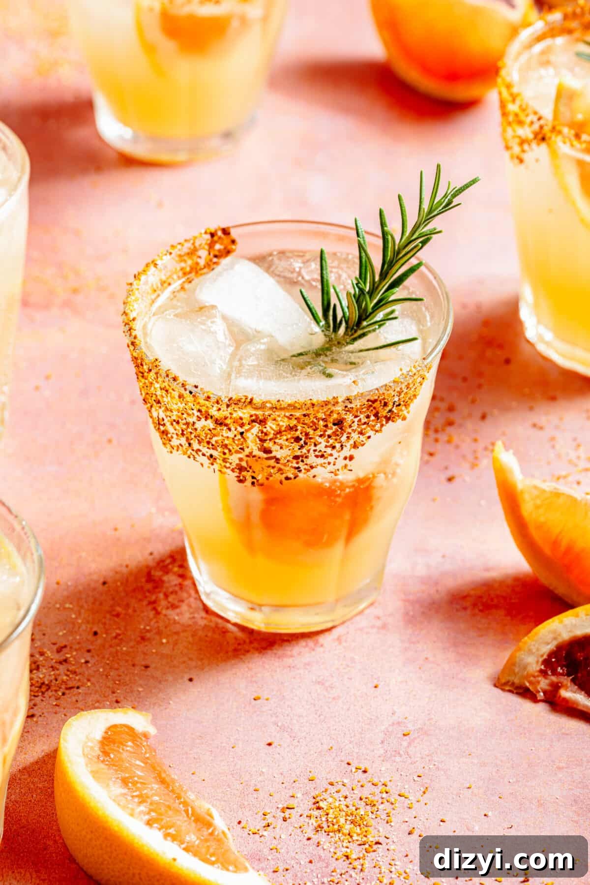 Skinny Rosemary Paloma in low glass with grapefruit and rosemary garnish.