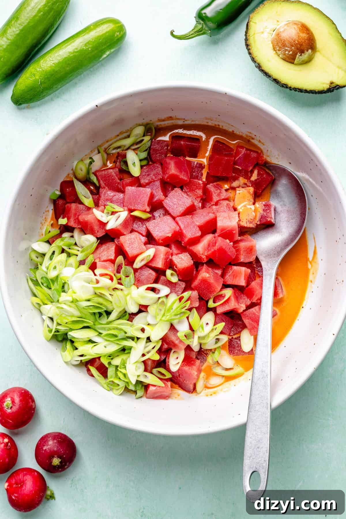 Spicy Hawaiian Ahi Poke Bowl Recipe 5 Hawaiian-Inspired Spicy Tuna Poke ingredients in bowl before stirring.