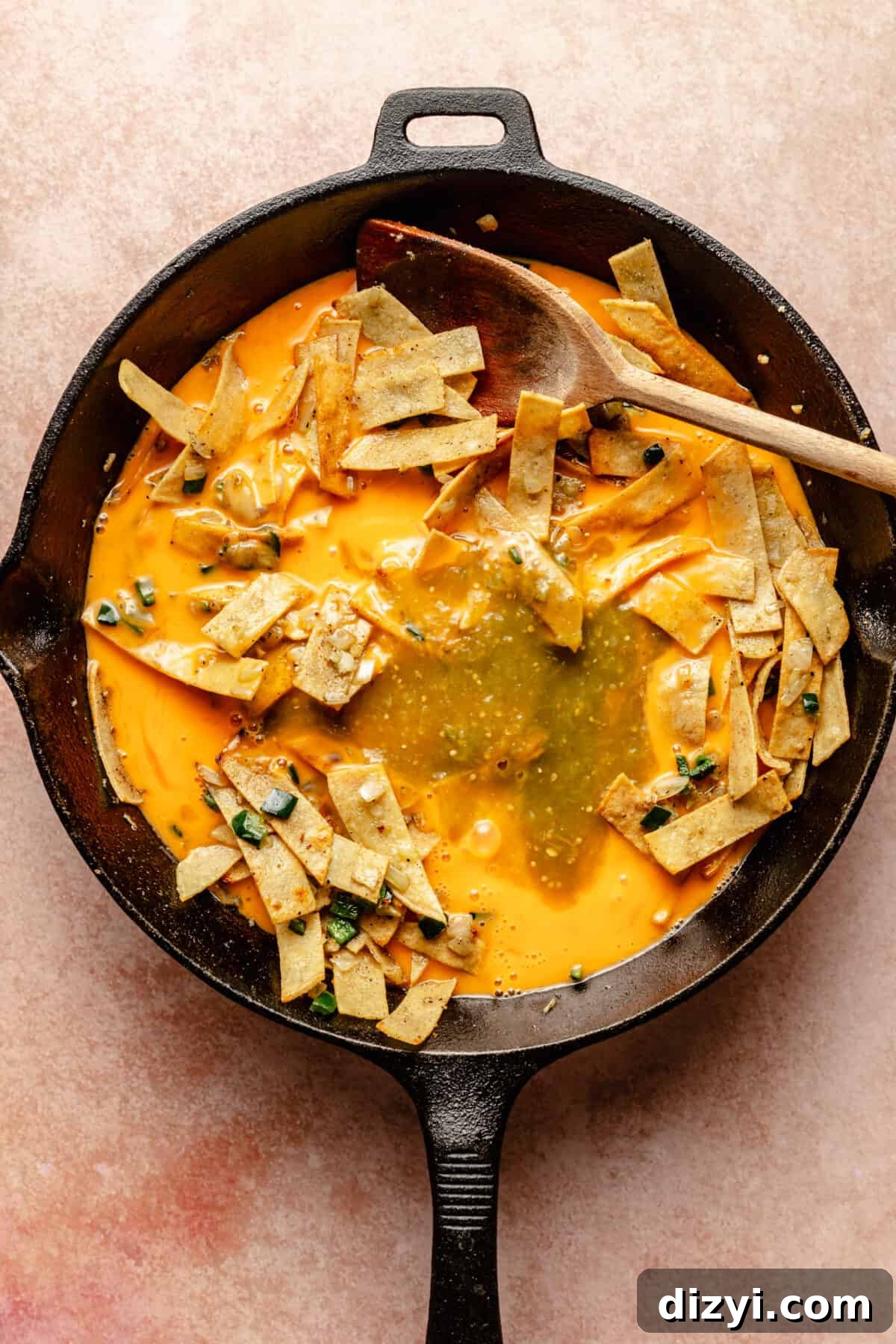 Tex-Mex Migas: Eggs, Salsa and Crispy Tortilla Chips 6 Migas cooking in cast iron skillet. Eggs partially cooked.