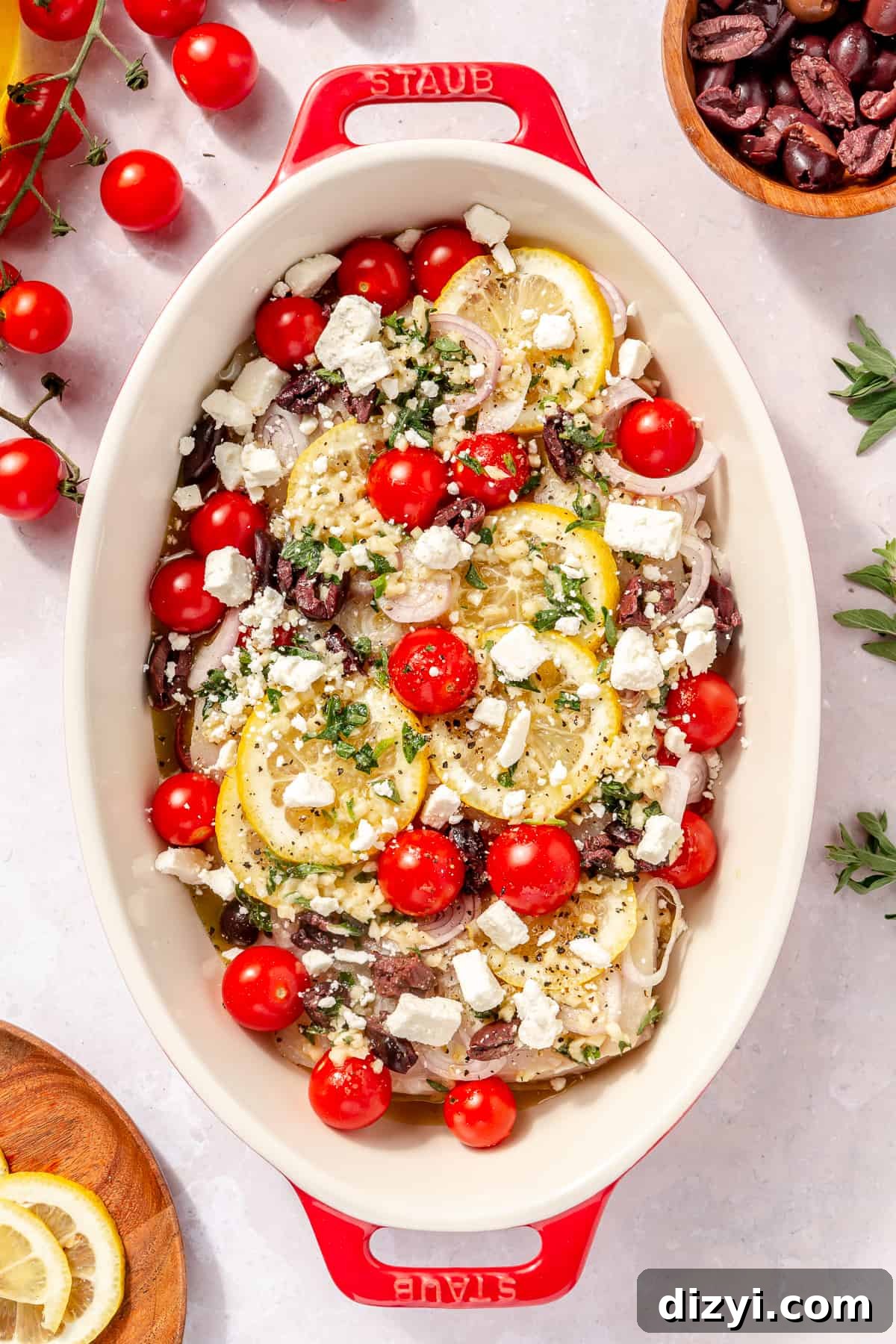 Greek-Inspired Halibut in oval baking dish before it is baked.