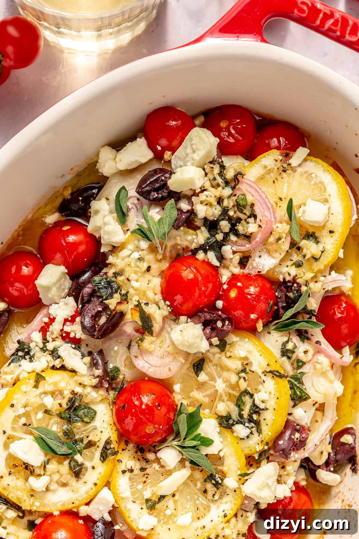 Close up of Oven-Baked Greek-Inspired Halibut in oval baking dish.