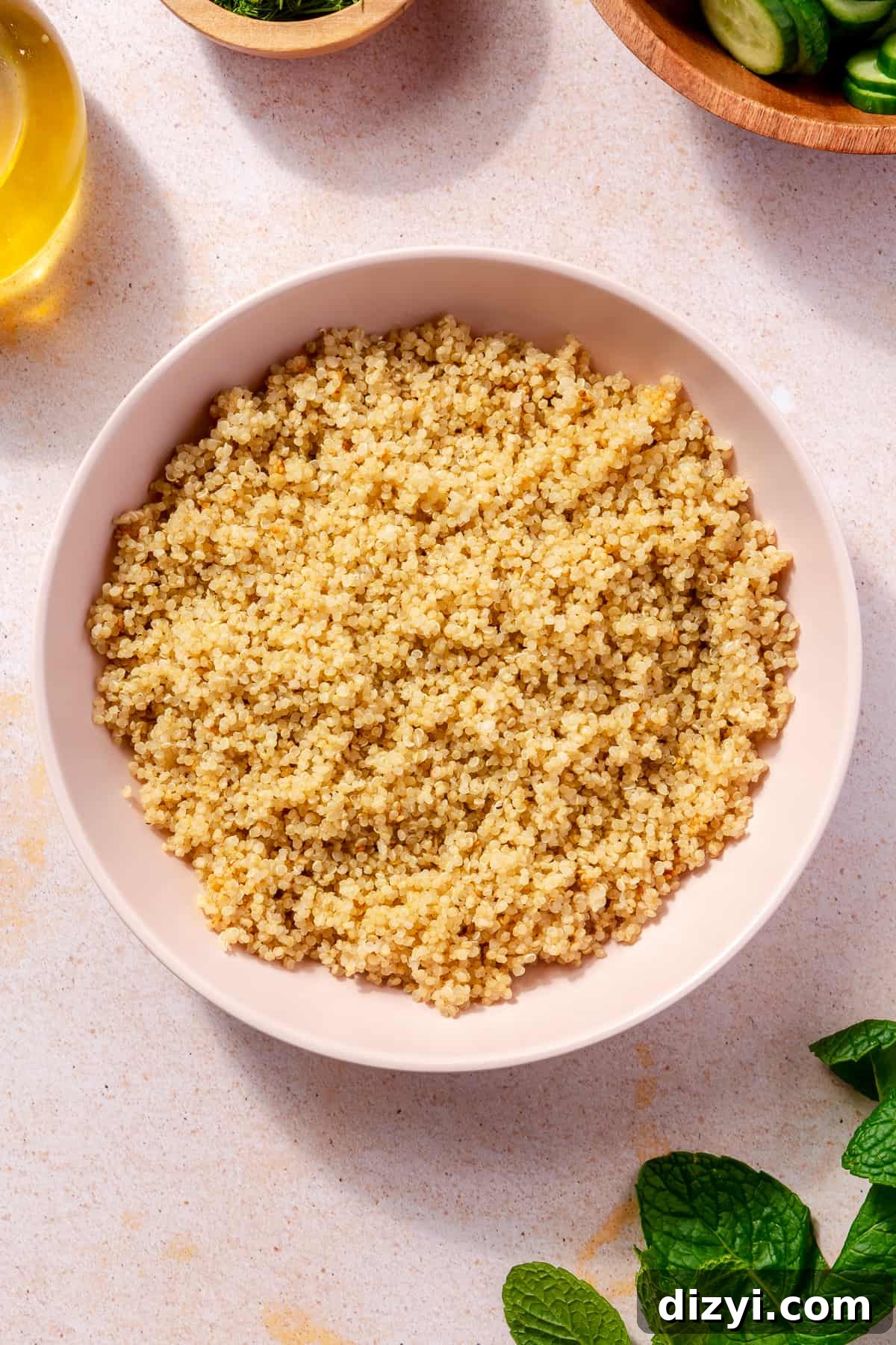 Cooked quinoa in large pink bowl.