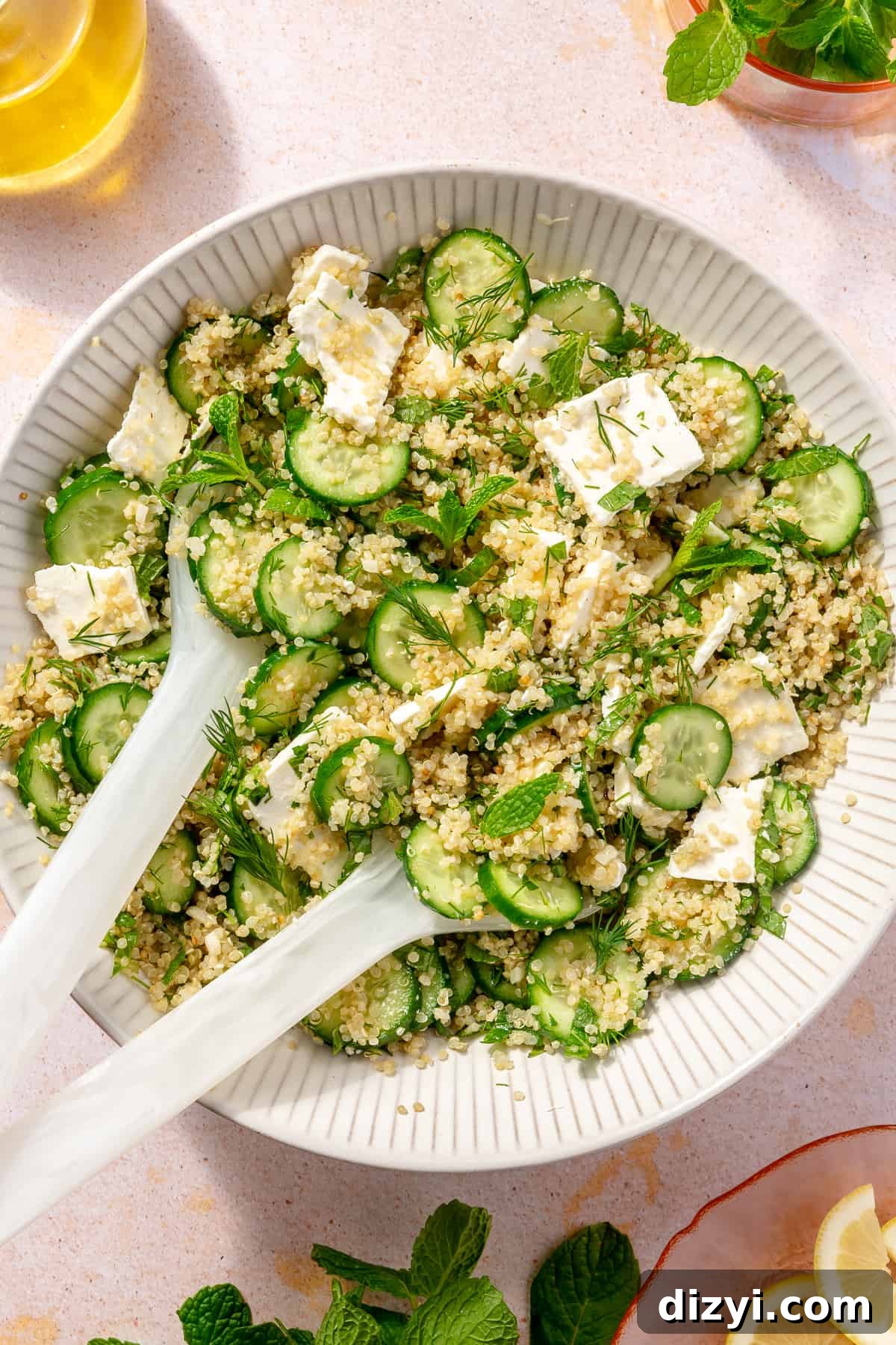 Quinoa salad tossed with all ingredients in large bowl.