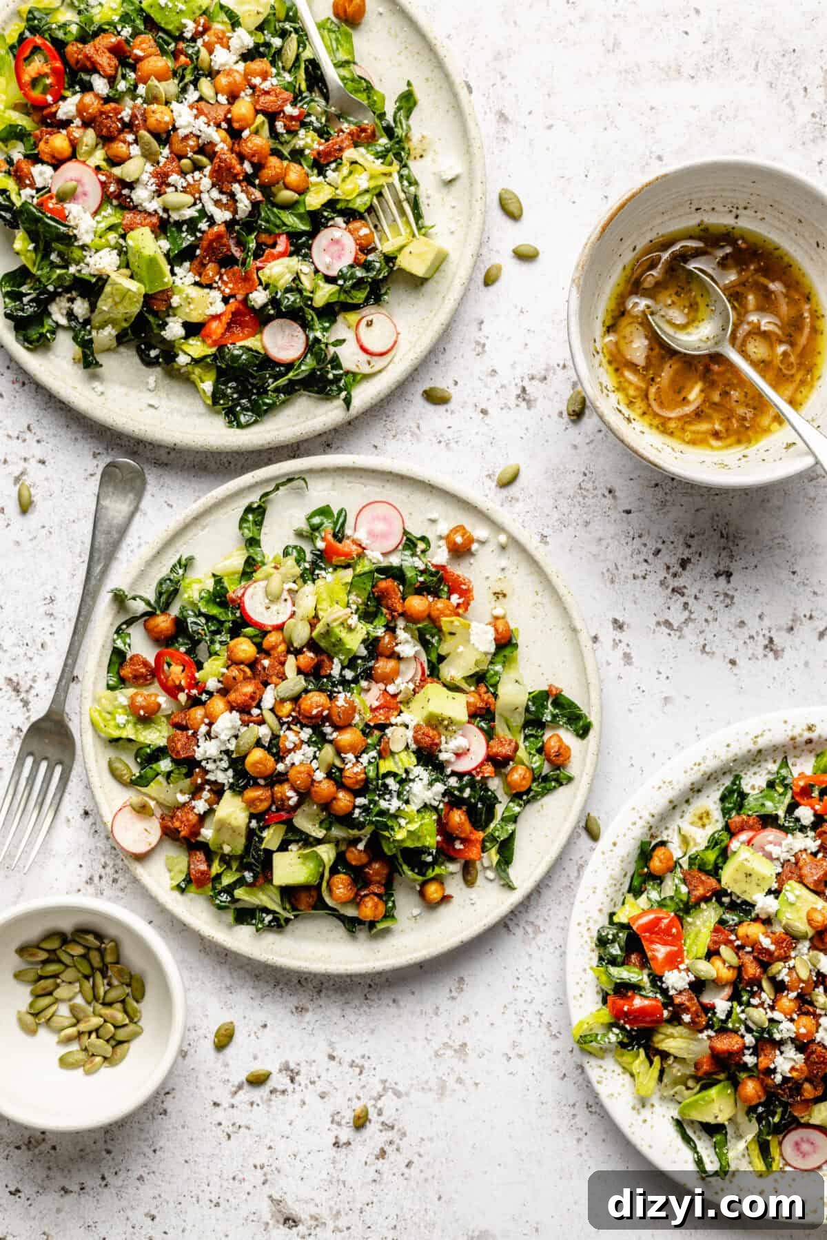 Mexican Chopped Salad with Avocado and Cilantro-Lime Dressing 2 Three white plates with salad, a small white bowl with the vinaigrette and a spoon.