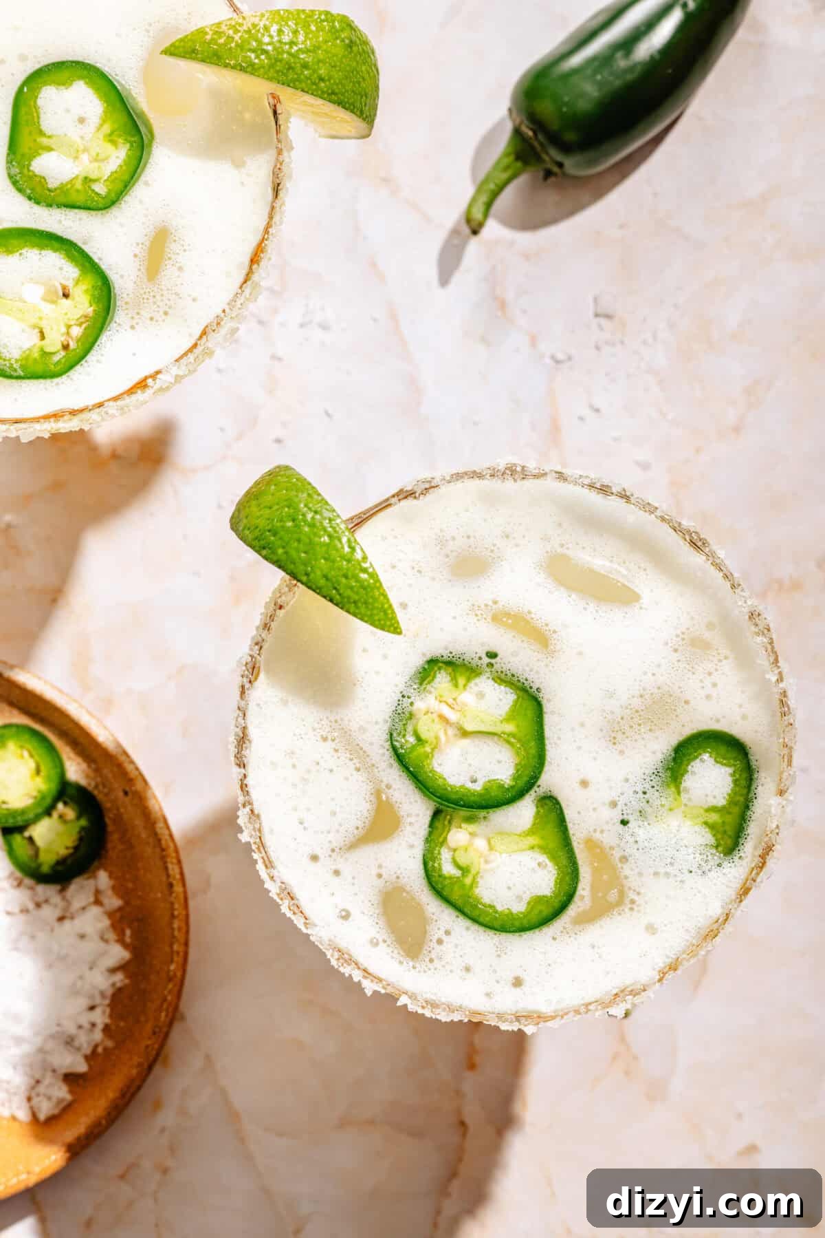 overhead photo of skinny margaritas with lime and jalapeno peppers
