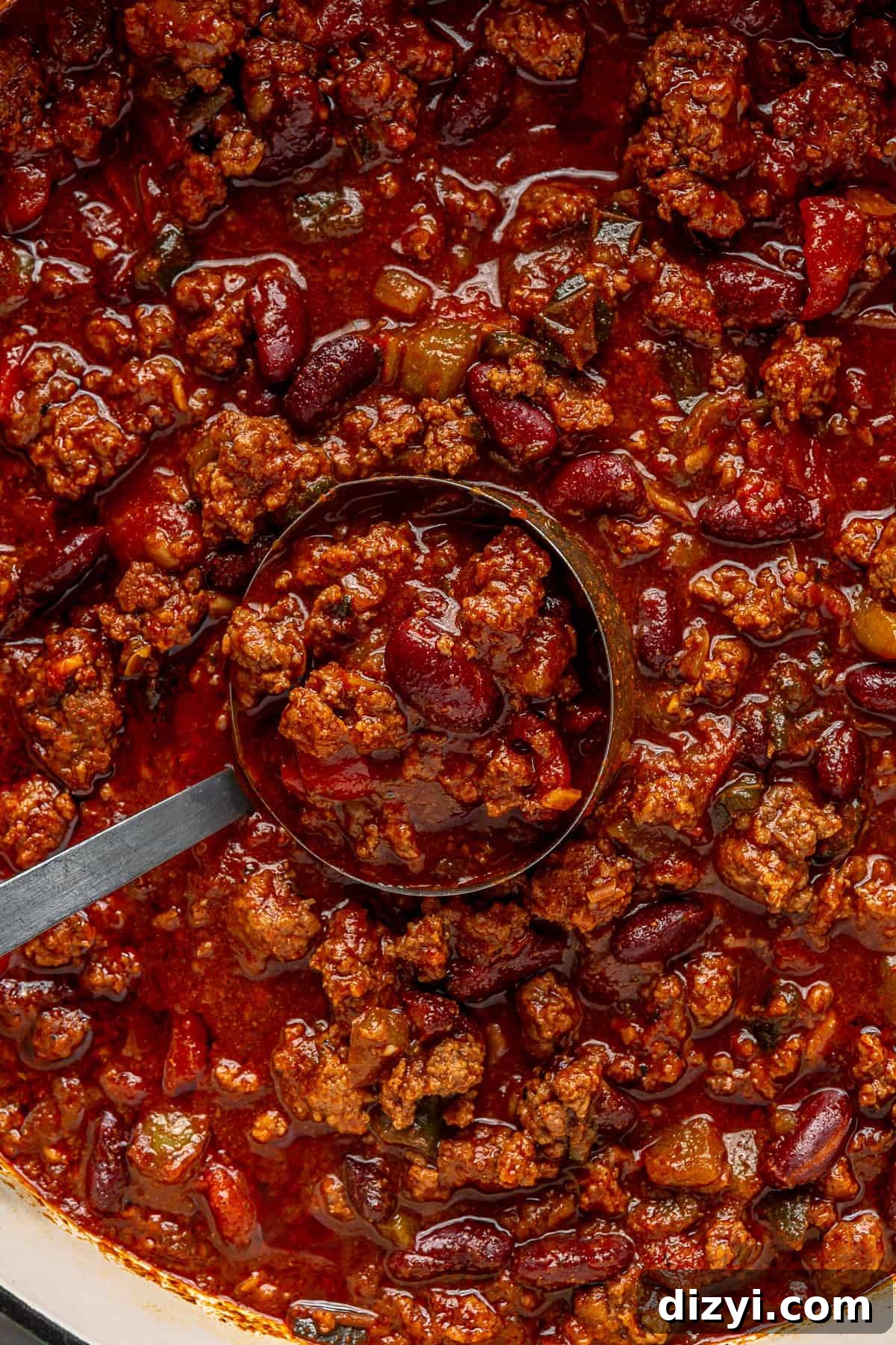 A close up shot of the Beef Chili with Beans in a pot, with a ladle.