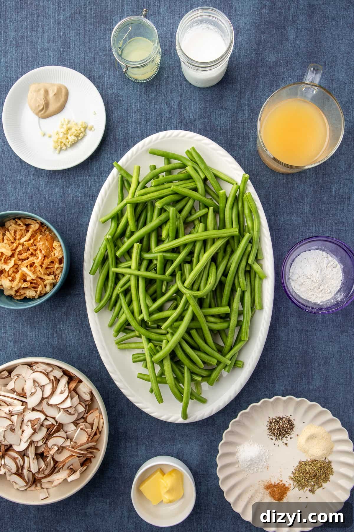 Ingredients for Homemade Green Bean Casserole scattered on dark background