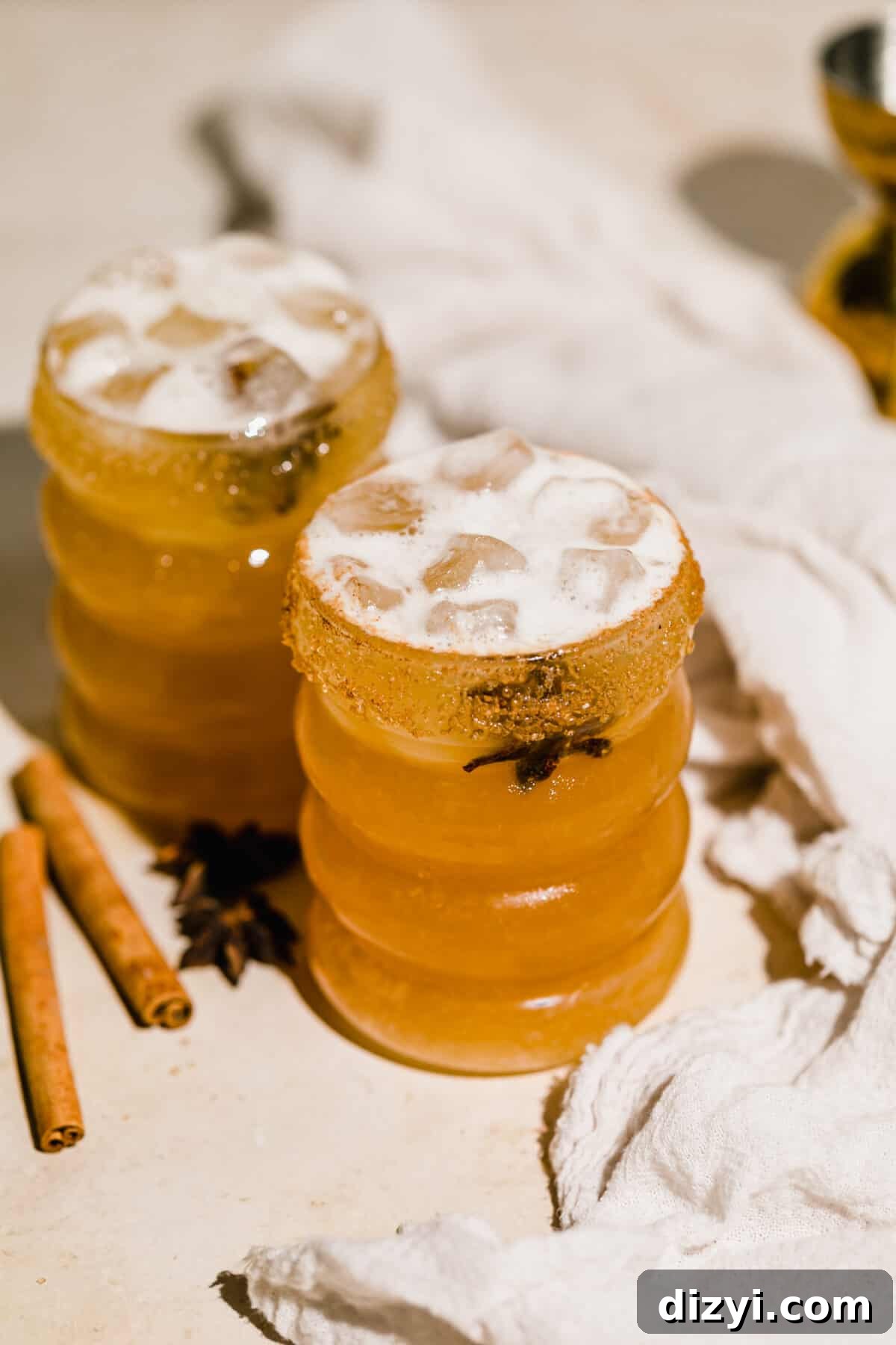 Fall Spiced Apple Cider Margarita Recipe 2 Two Spiced Apple Cider Margaritas with cloth napkin and cinnamon sticks