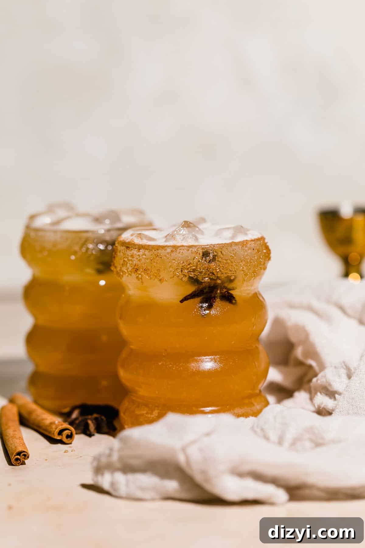 Fall Spiced Apple Cider Margarita Recipe 3 Two Spiced Apple Cider Margaritas with cloth napkin and cinnamon sticks