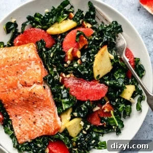 Bowl of shredded kale salad with grapefruit and grated cheddar