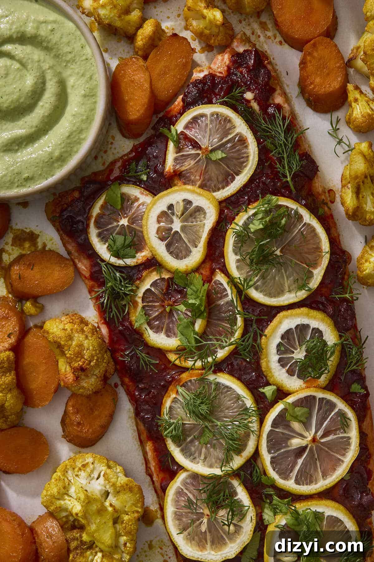 Sheet Pan Harissa Salmon + Roasted Veggies with Cashew Crema on sheet pan.