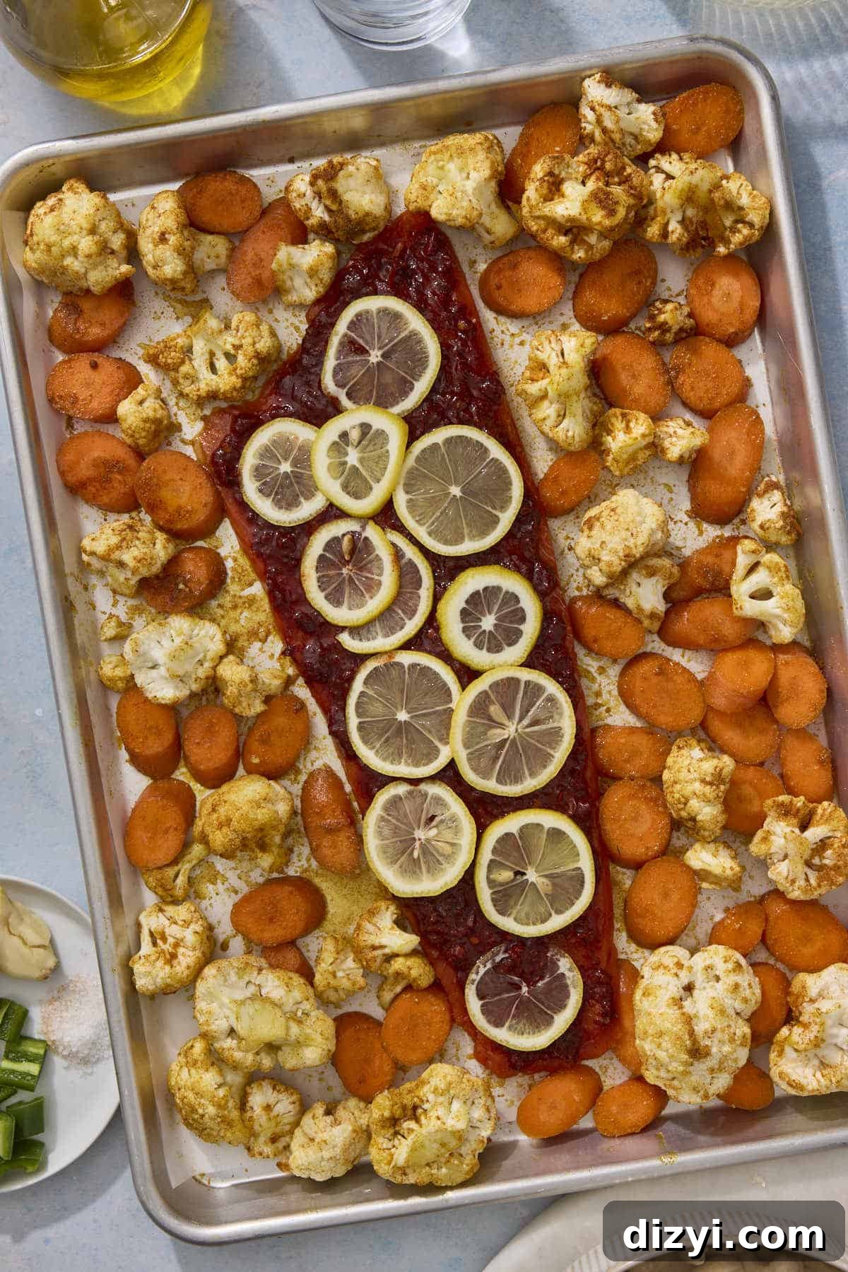 Sheet Pan Harissa Salmon + Roasted Veggies before they are roasted in oven.