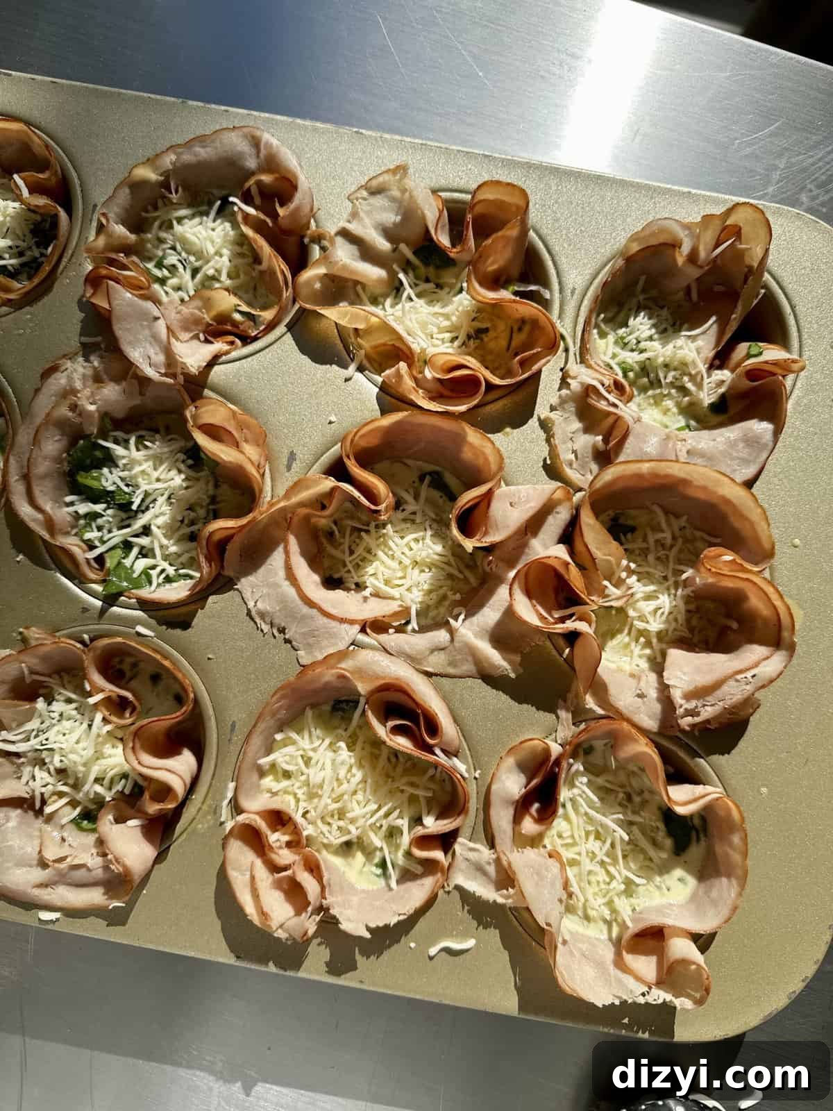 Baked egg bites cooling in a muffin tin