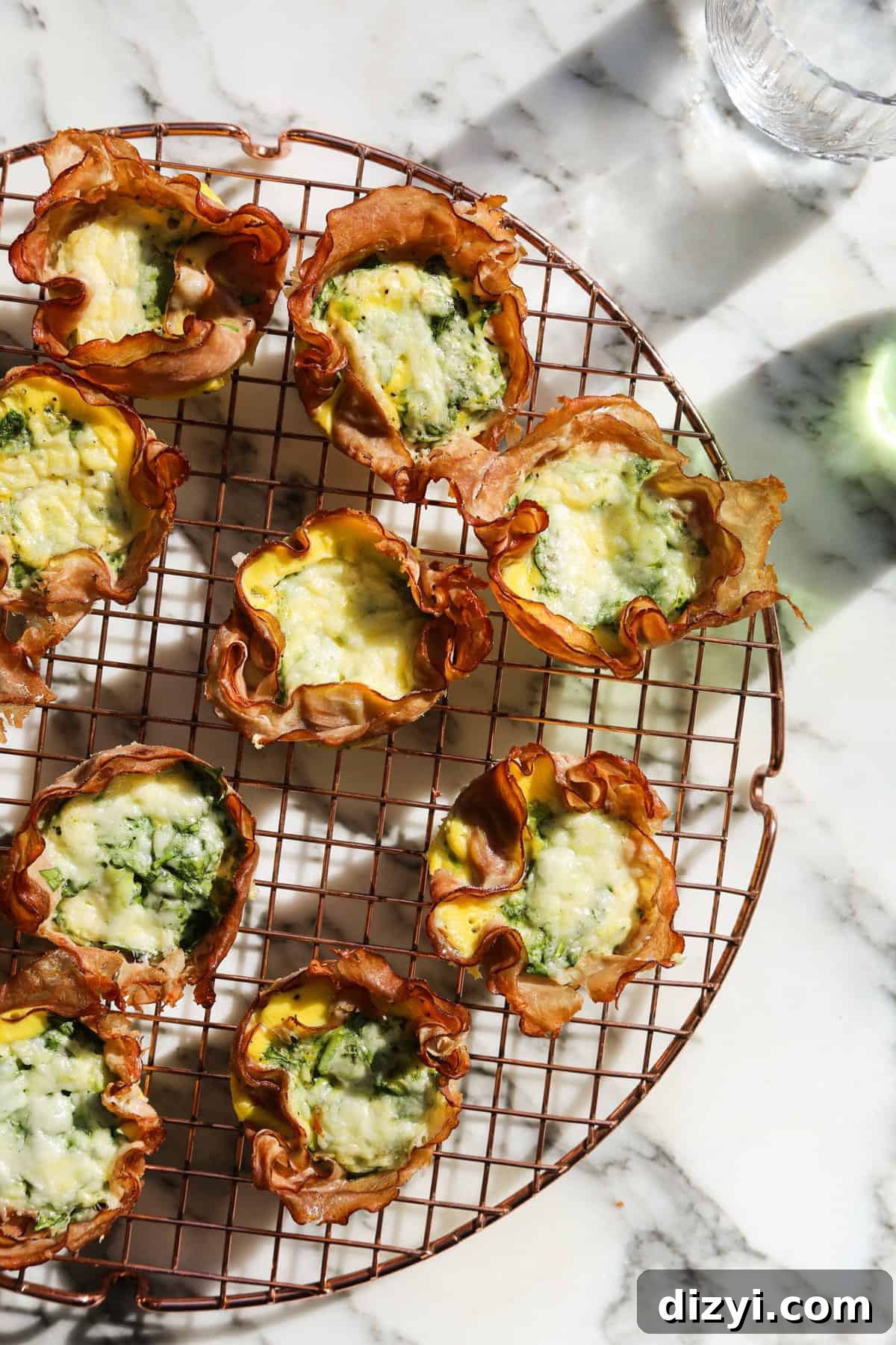 Close up of a ham lined muffin cup with egg filling