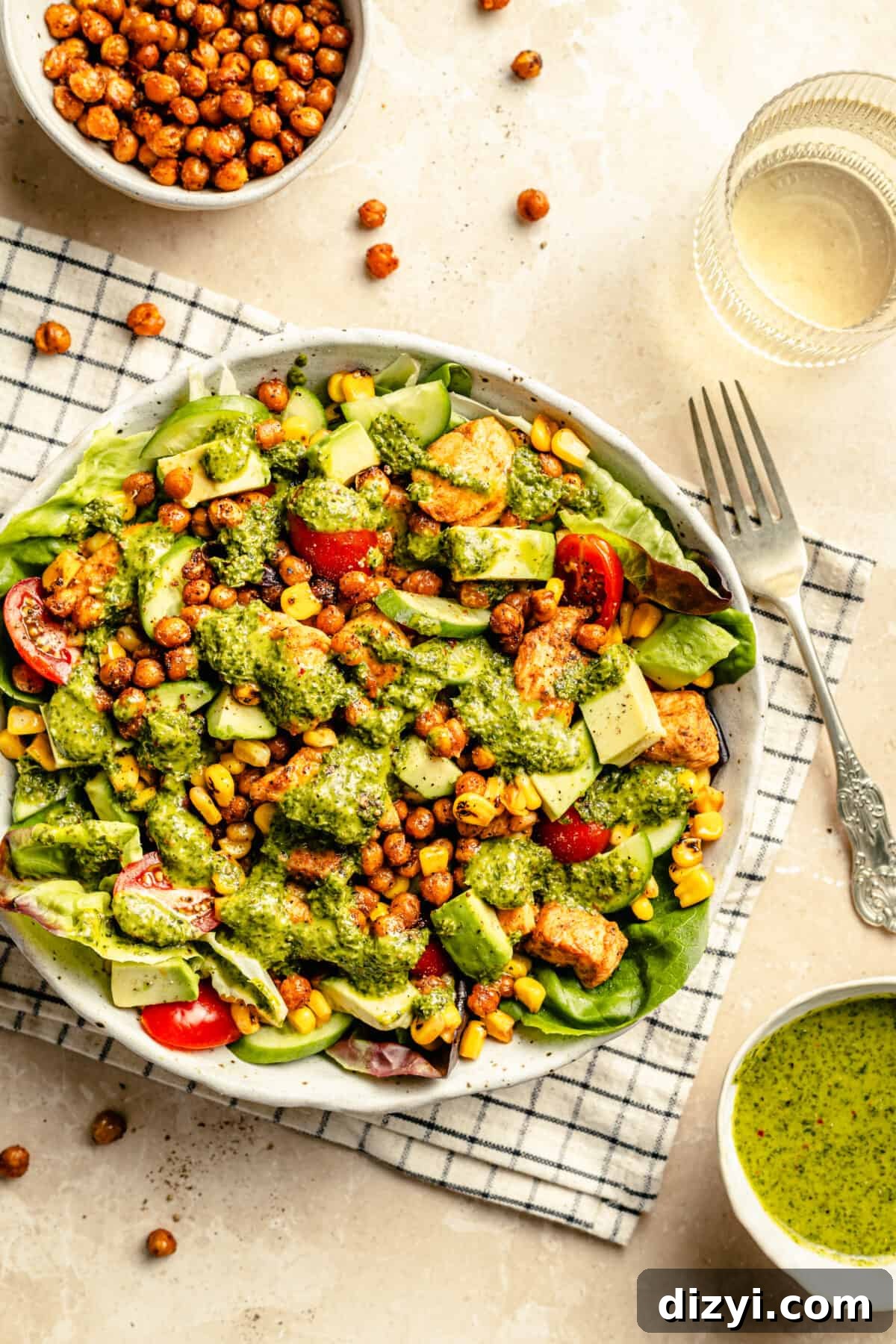 Salad in large bowl on tope of a checkered towel on neutral backdrop.