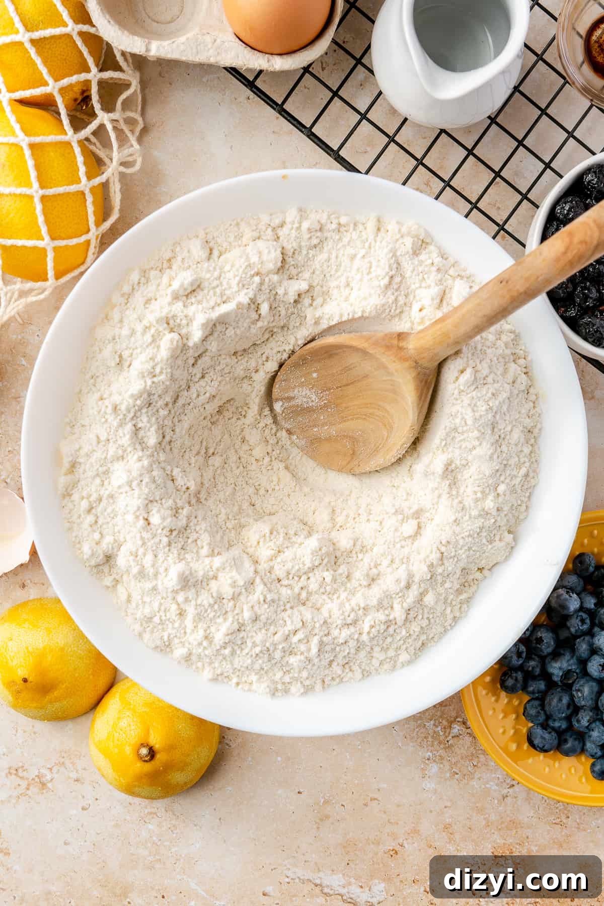 Bowl of dry ingredients and butter with wooden spoon in the center.