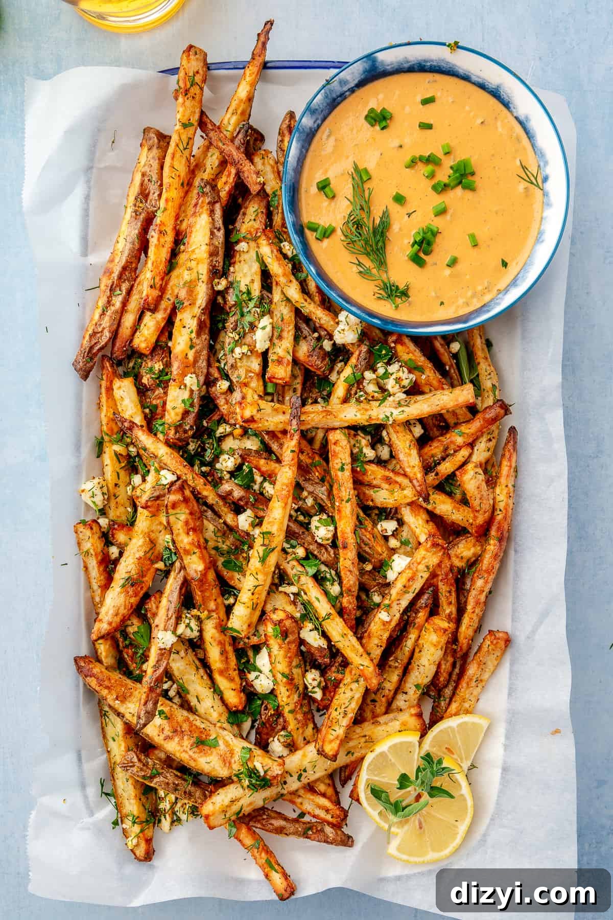 Crispy Greek Feta Fries with Romesco Ranch Dip 2 Platter lined with parchment paper filled with Greek-inspired Feta Fries with side bowl of Romesco Ranch.