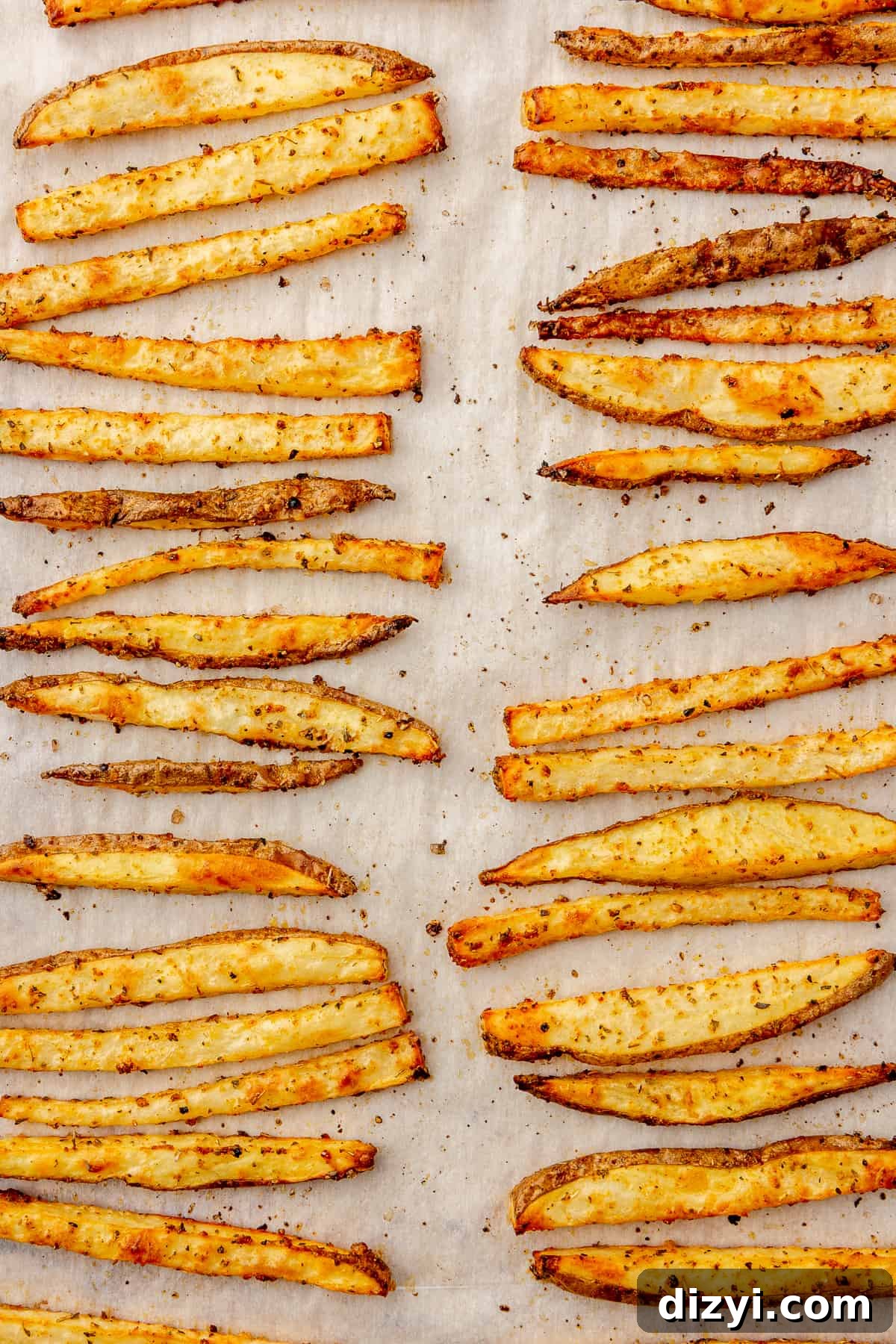 Crispy Greek Feta Fries with Romesco Ranch Dip 5 Seasoned baked fries on a sheet pan.