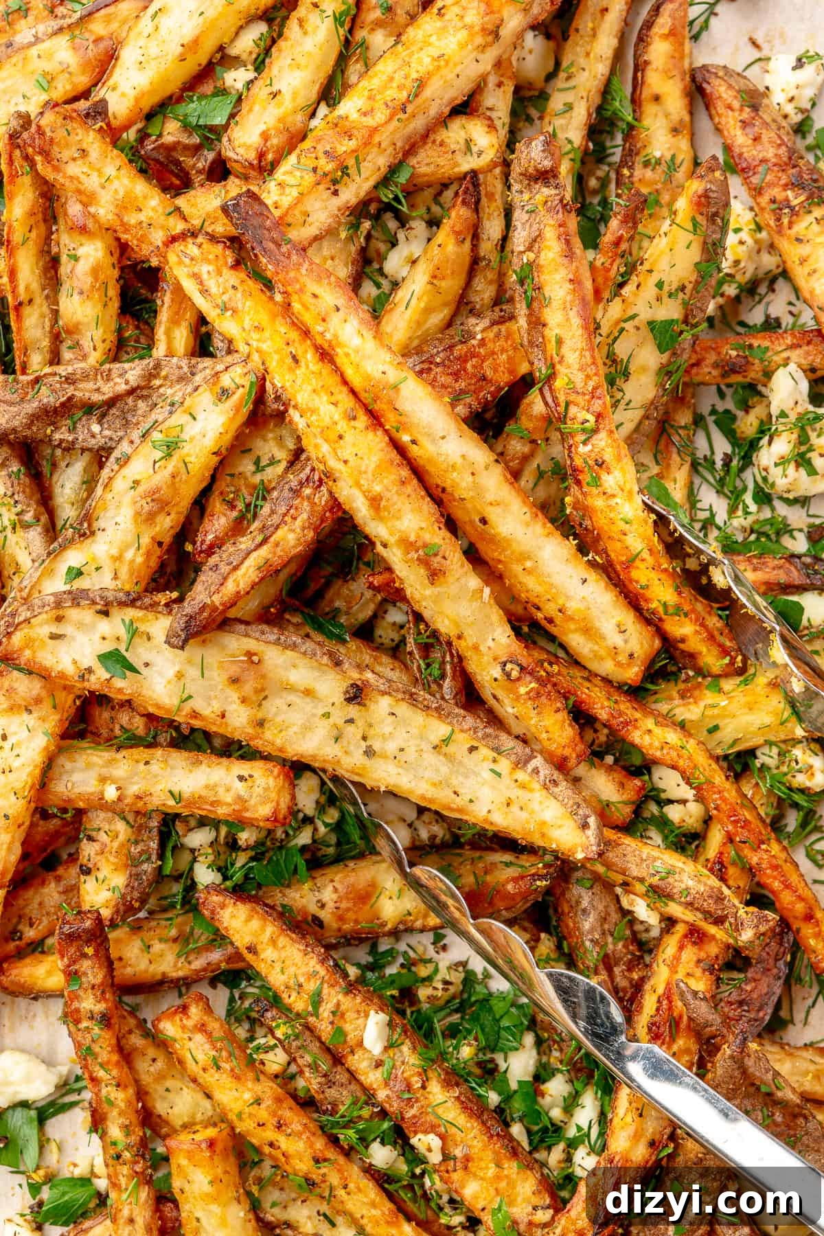 Crispy Greek Feta Fries with Romesco Ranch Dip 7 Close up of fries on sheet pan with garlic and herbs.