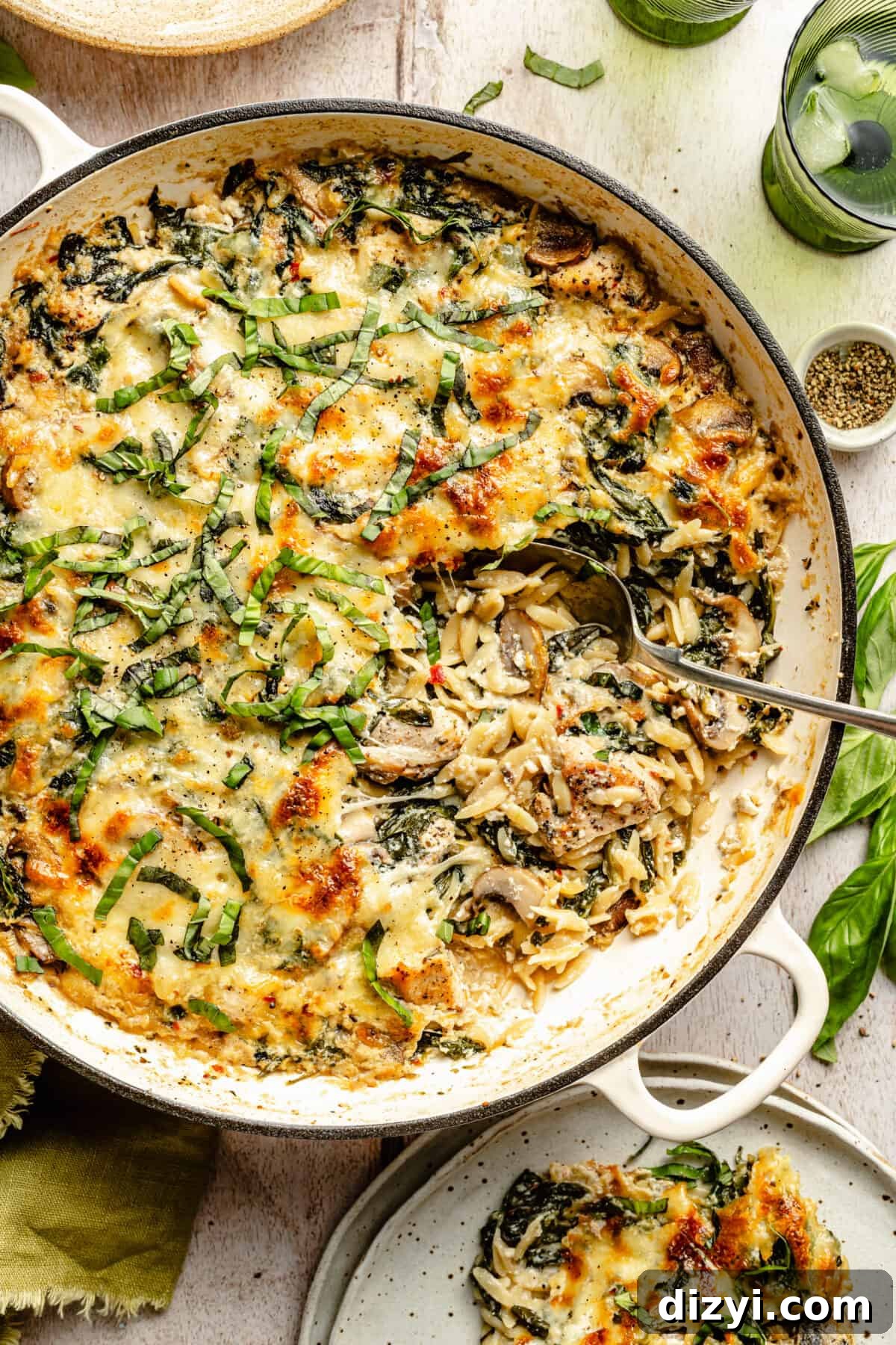 Creamy Ricotta Chicken and Orzo Skillet with spoon in it scooping it out.