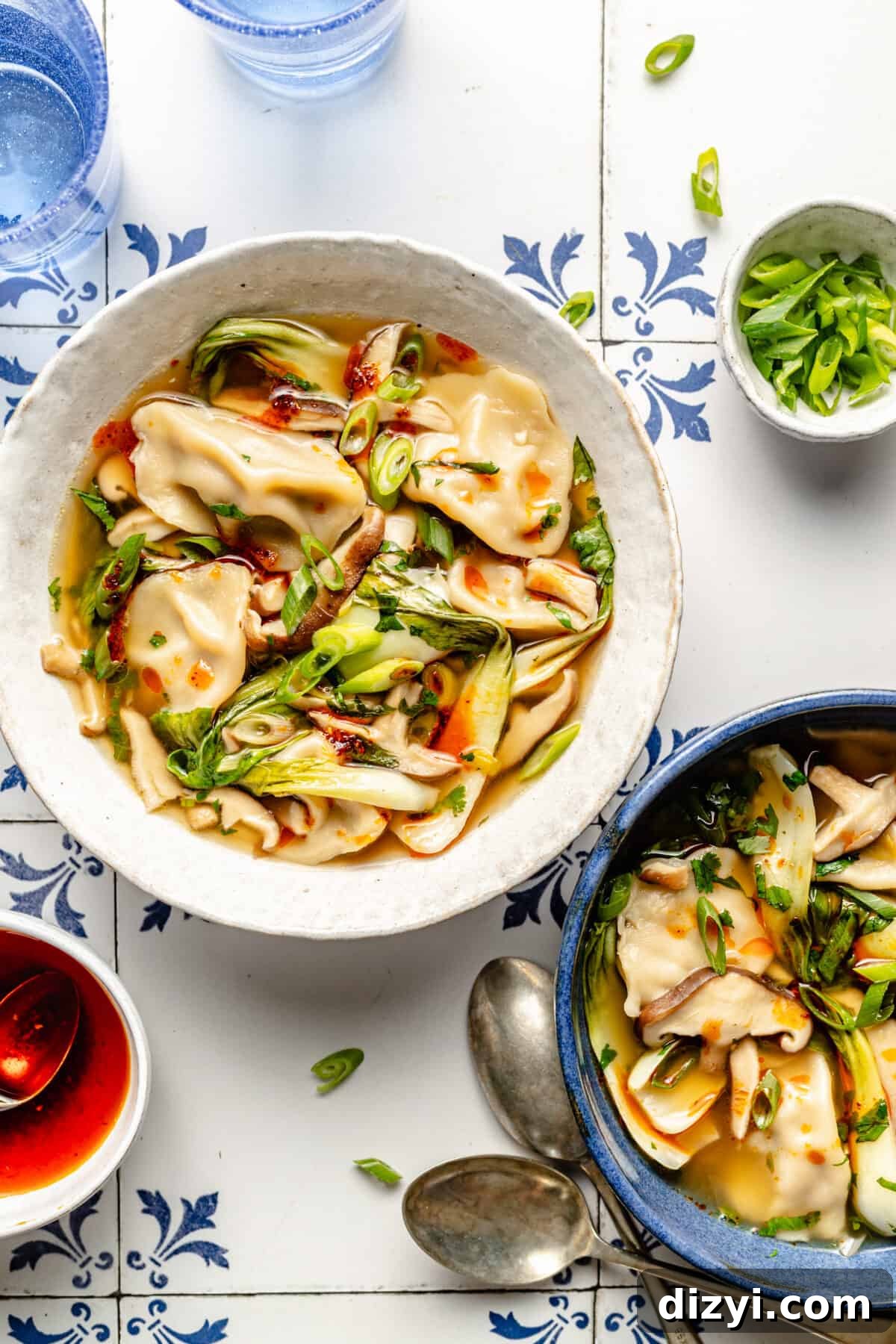 Two bowls of 20-Minute Wonton Soup on blue and white tile.