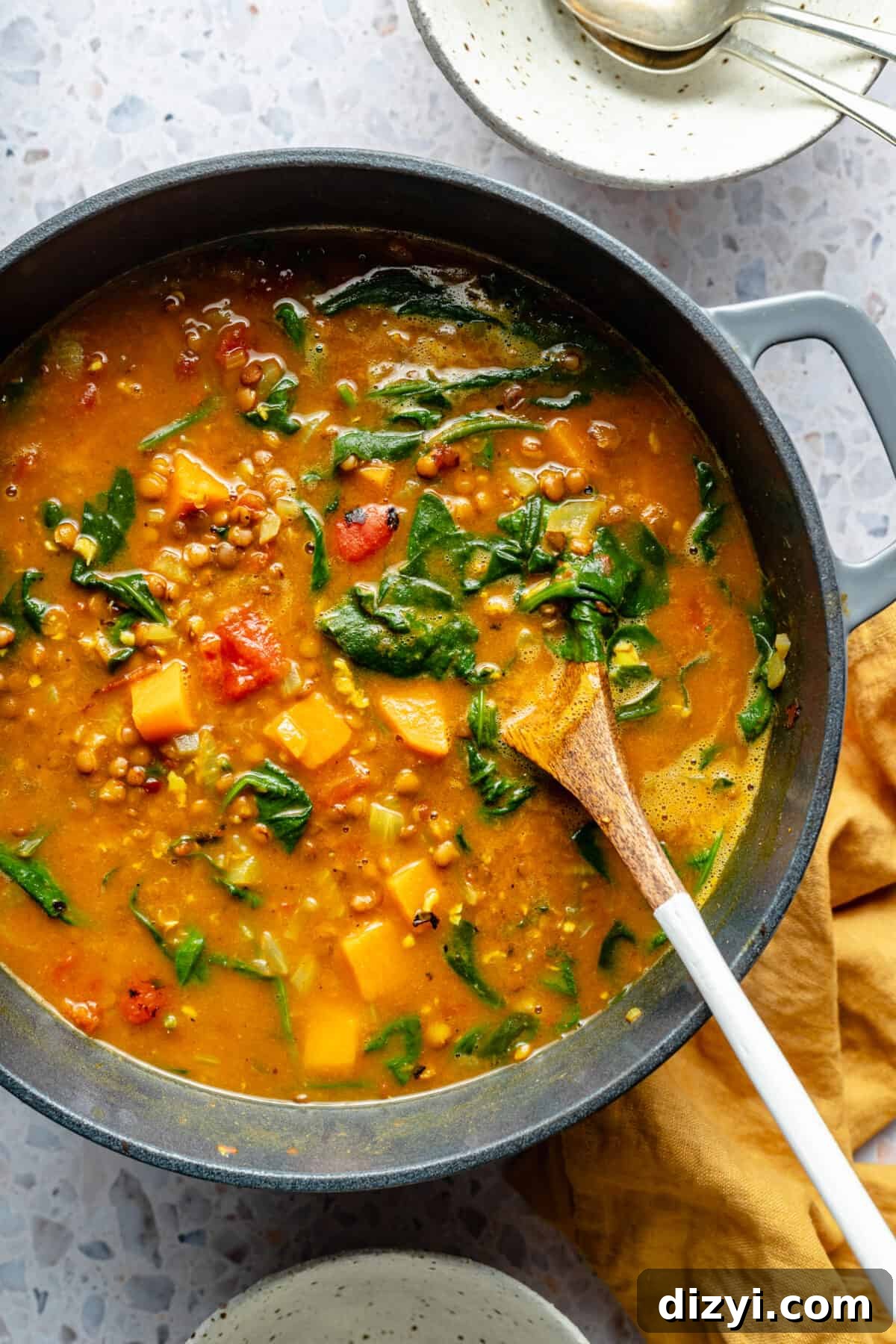 Large pot of Curried Lentil Soup with spinach in it.