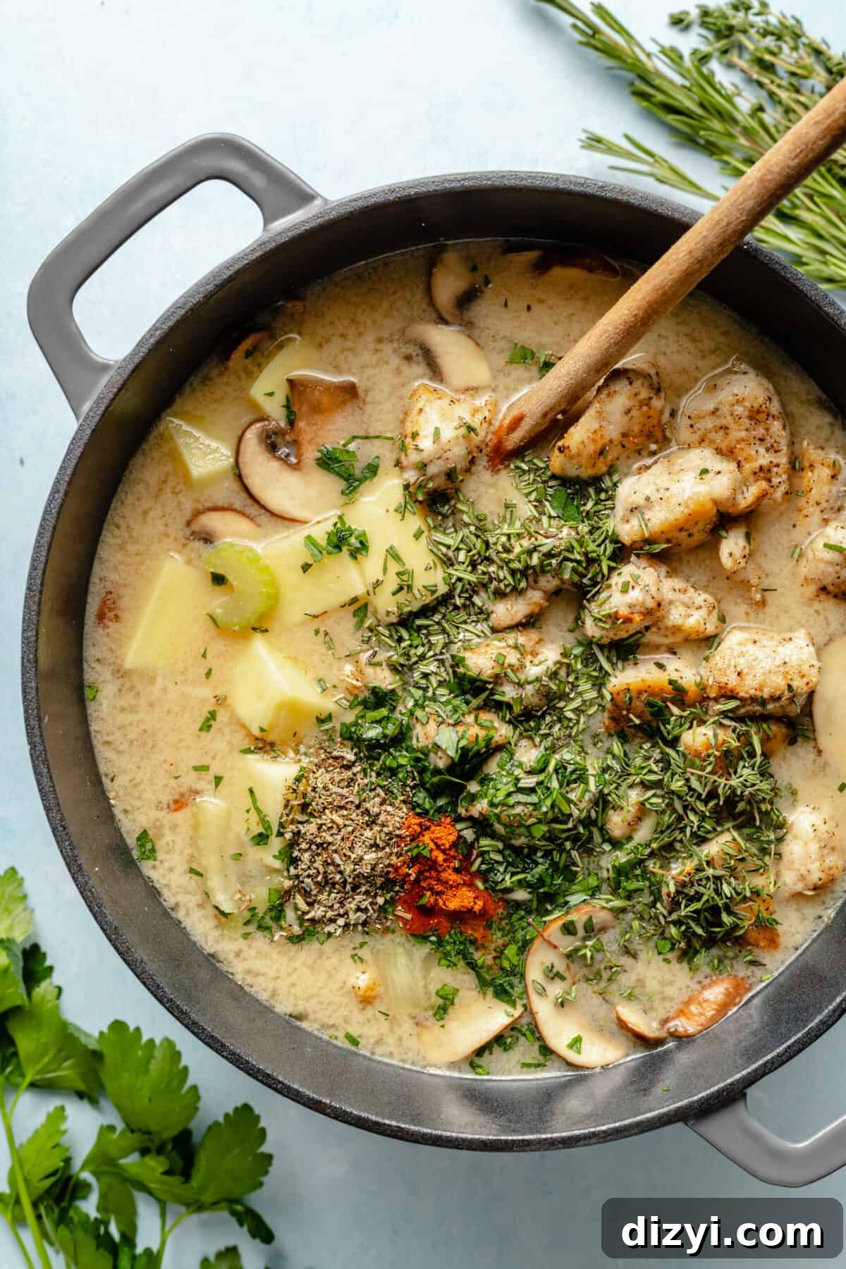 Classic Chicken Stew Recipe with Tender Vegetables 6 Large pot of potatoes, veggies, and chicken in broth. Herbs floating on top.