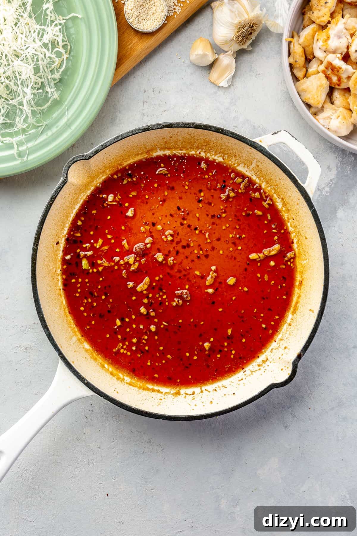 How to Make Honey Garlic Chicken Lettuce Wraps 7 Honey-Garlic sauce in a white skillet.