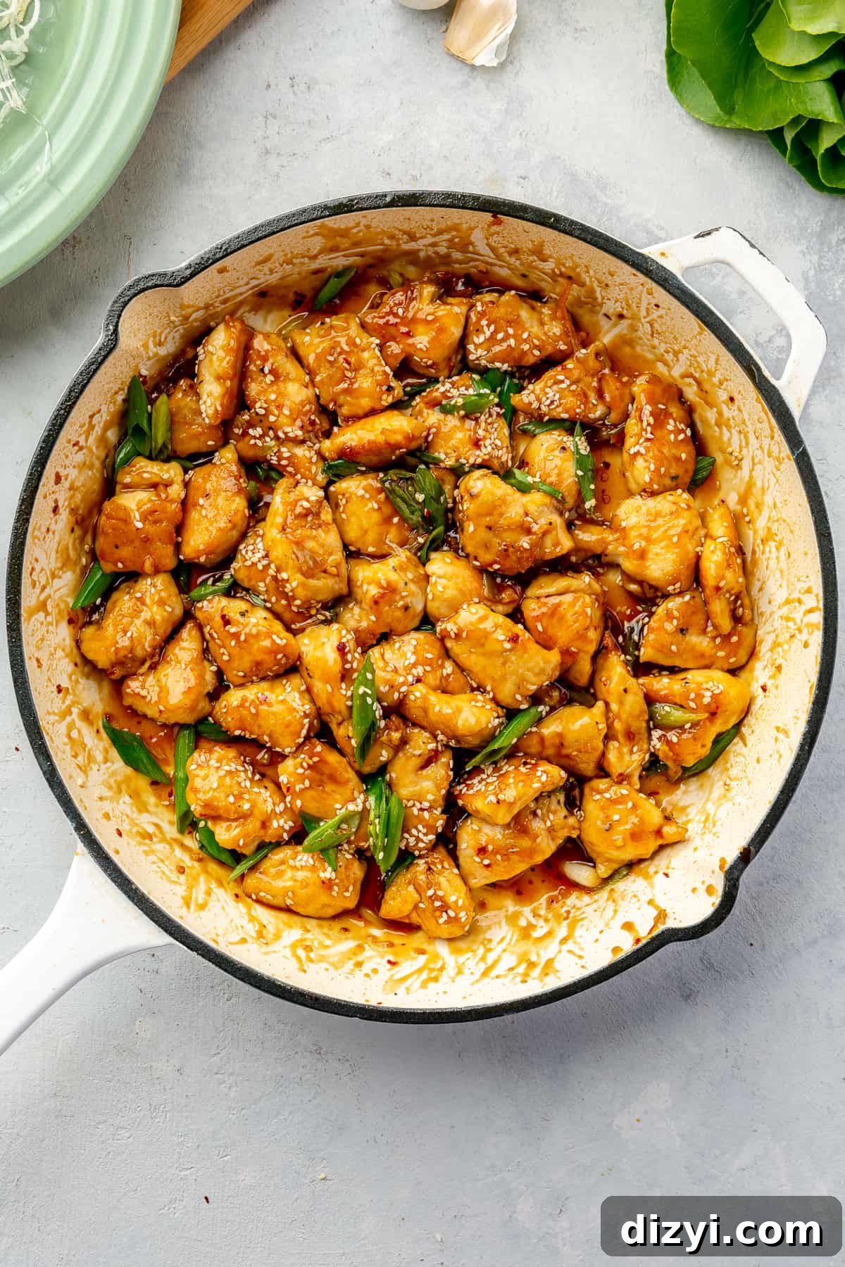 How to Make Honey Garlic Chicken Lettuce Wraps 8 Honey-Garlic Chicken in a white skillet.