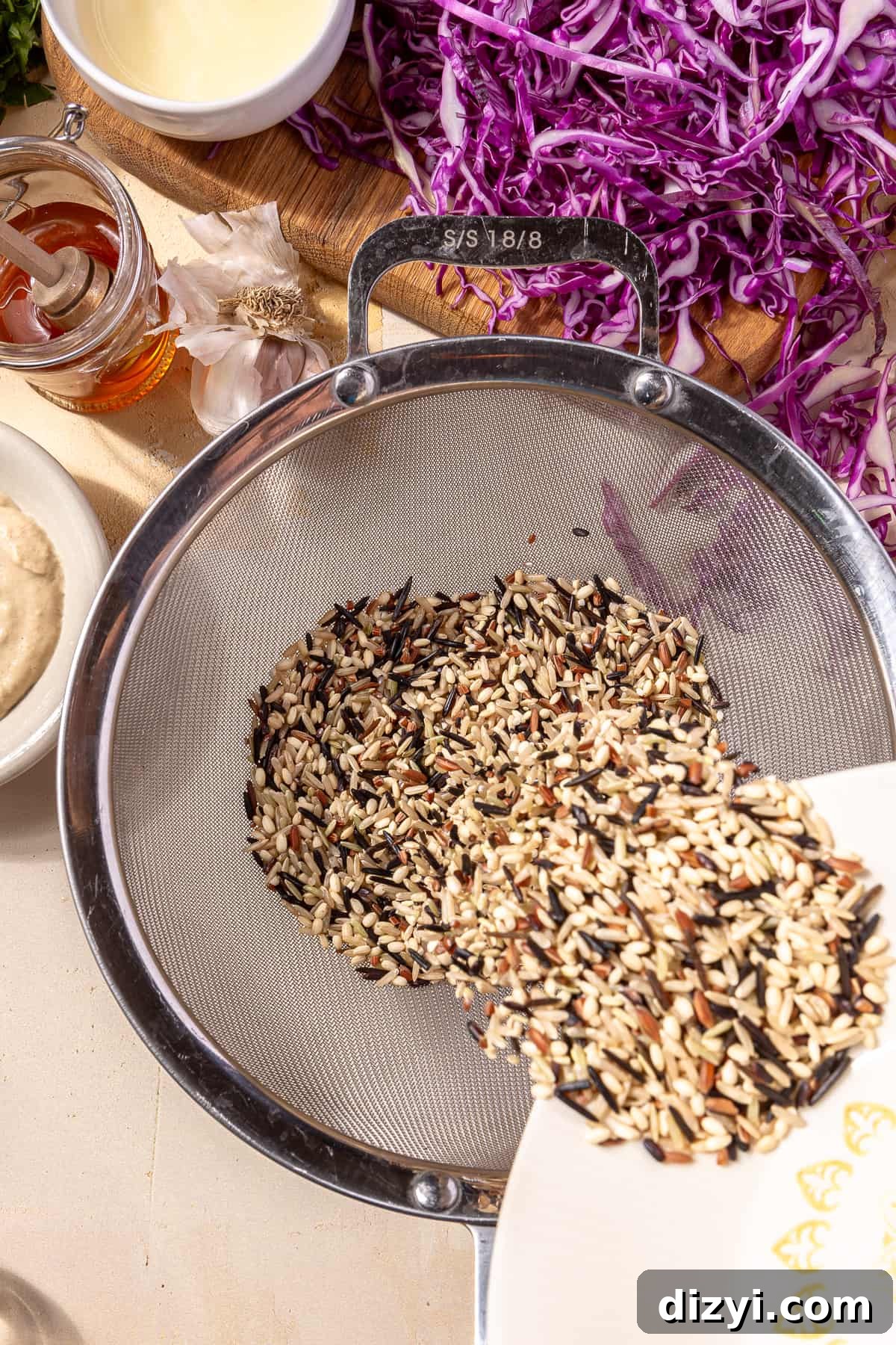 Sweetgreen Copycat Blackened Chicken and Sweet Potato Bowls 5 Wild rice bing poured into strainer.