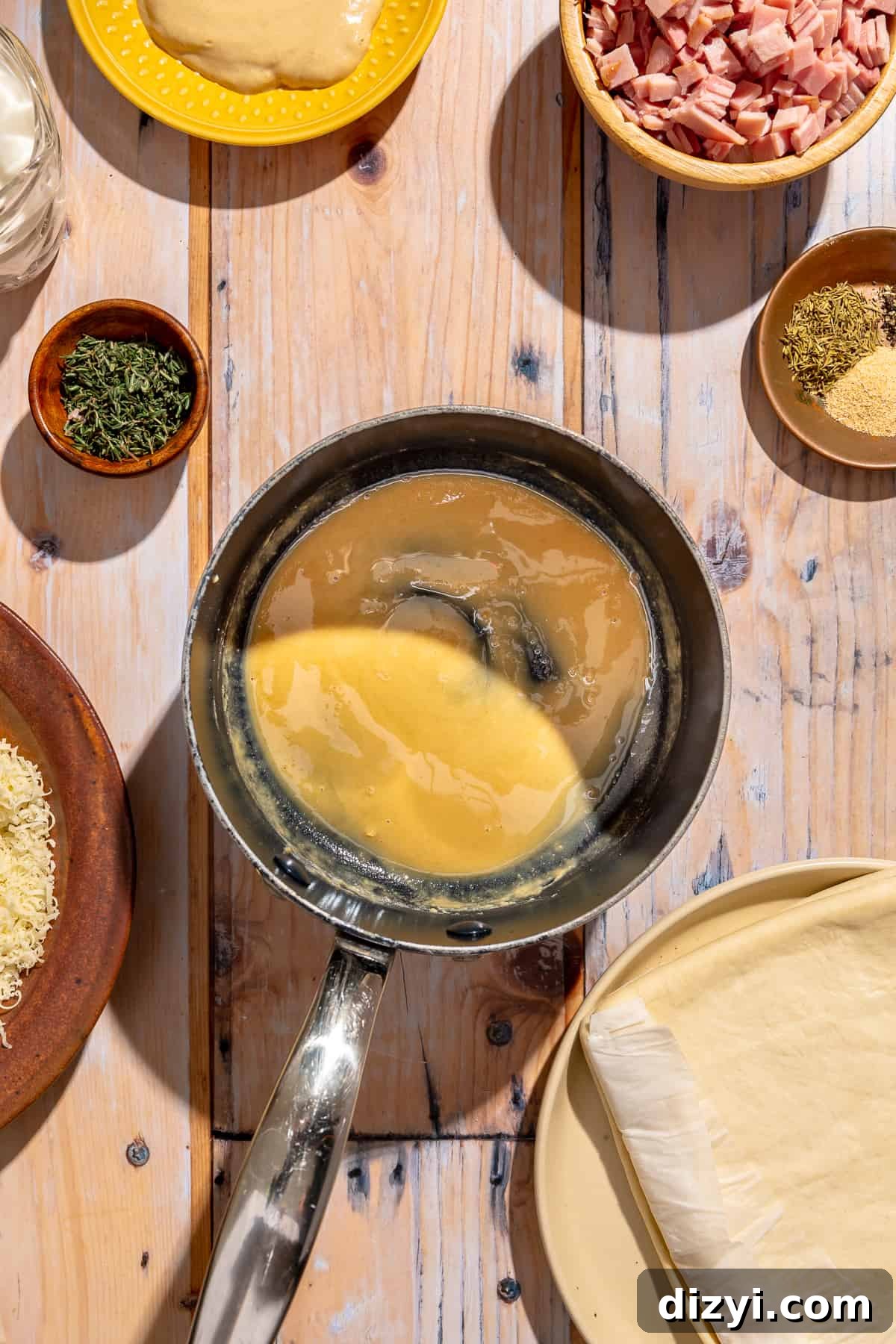 Roux for bechemal in a small saucepan. Other ingredients scatter around.